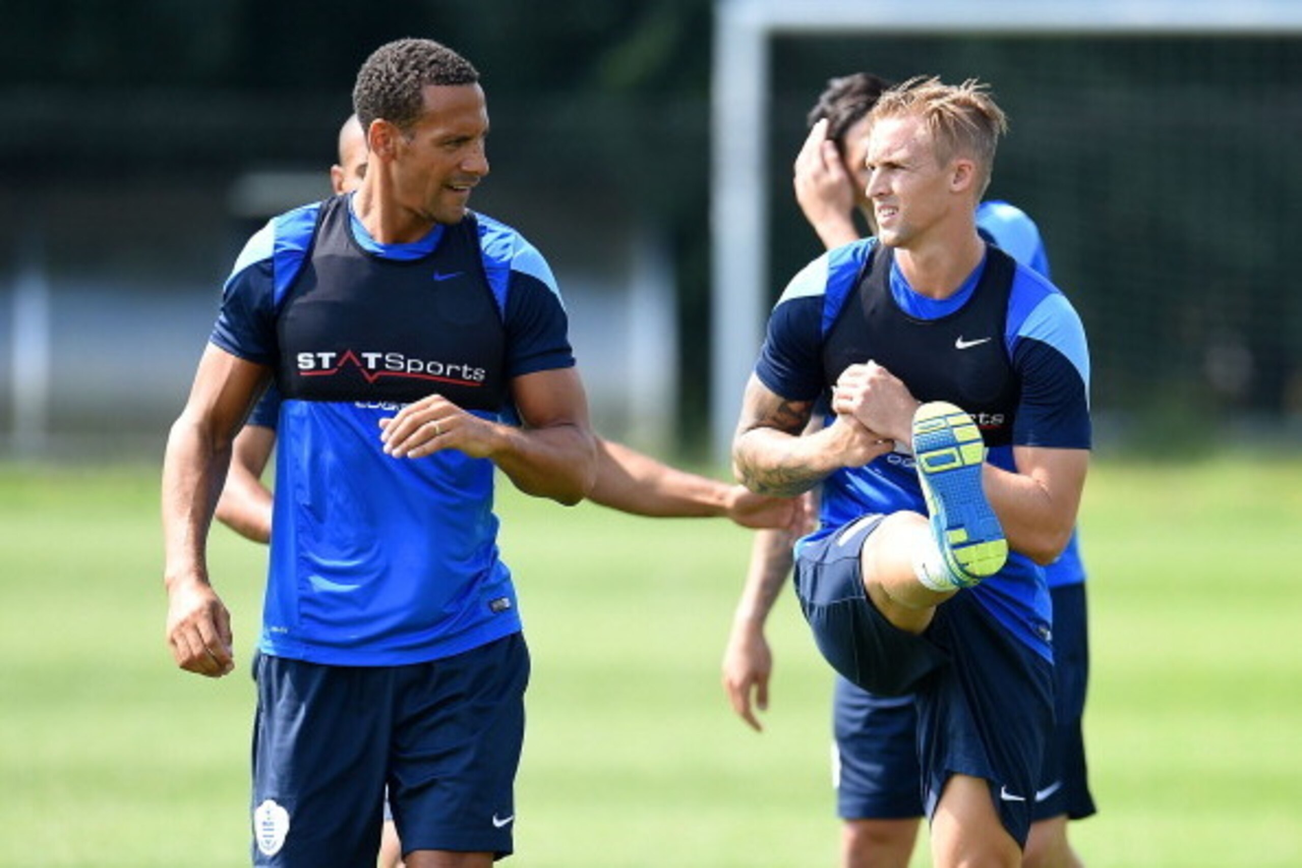 HARLINGTON, ENGLAND - JULY 18: Rio Ferdinand (L) and Jack Collison (R) warm up during a Queens Park Rangers training session on July 18, 2014 in Harlington, England. (Photo by Tom Dulat/Getty Images)