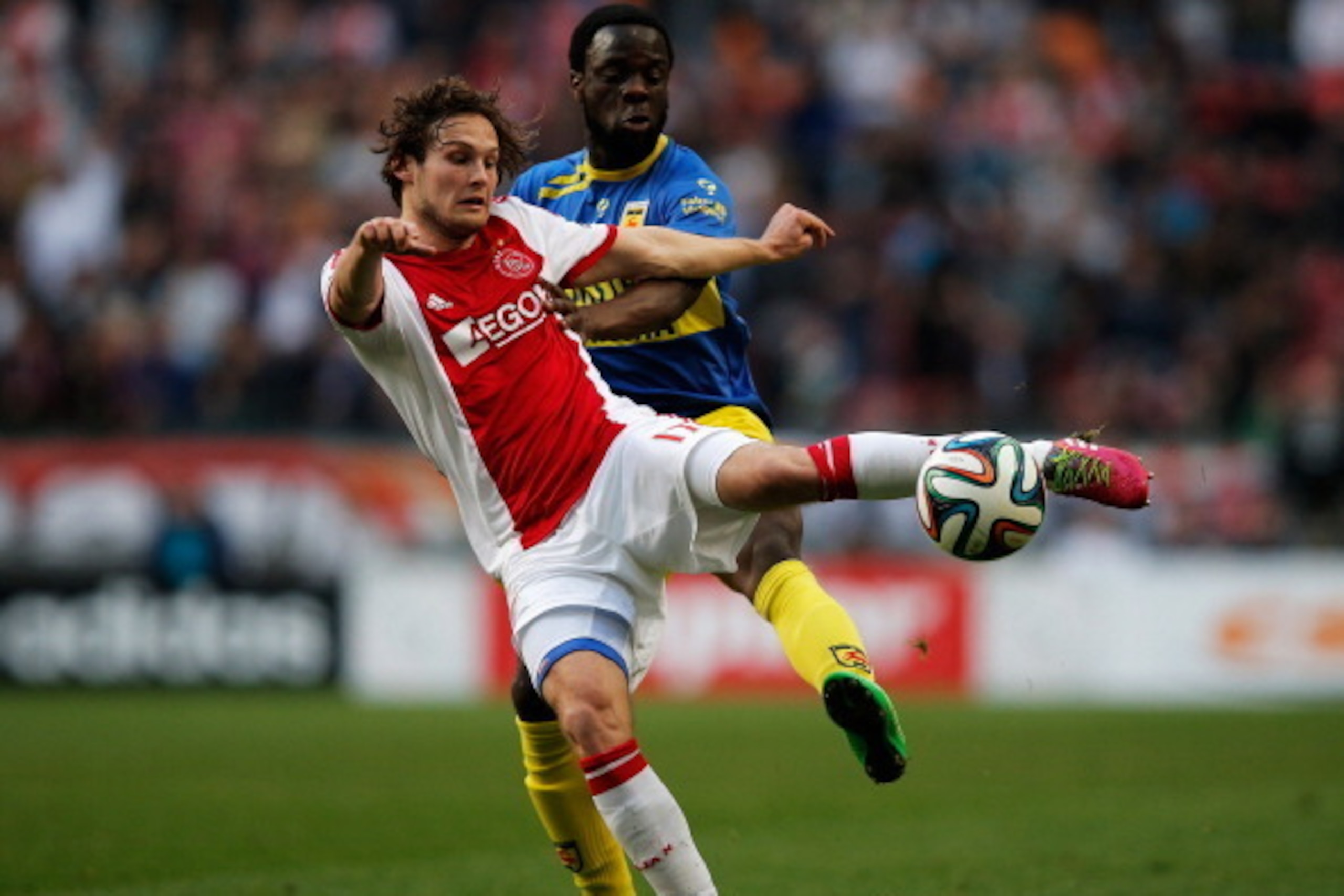 AMSTERDAM, NETHERLANDS - MARCH 09:  Daley Blind of Ajax clears the ball away from Elvis Manu of Cambuur during the Eredivisie match between Ajax Amsterdam and SC Cambuur Leeuwarden at Amsterdam Arena on March 9, 2014 in Amsterdam, Netherlands.  (Photo by 
