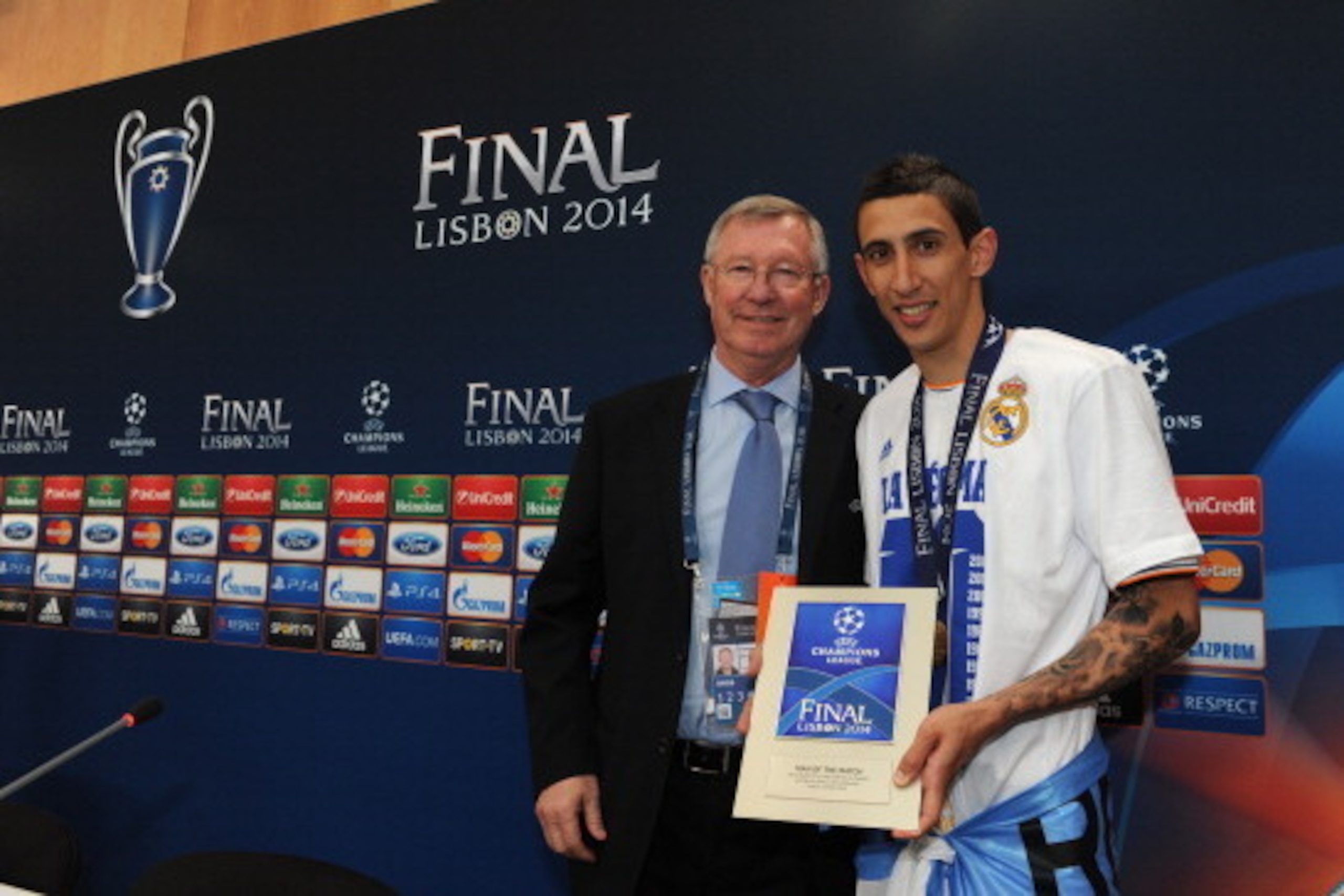 LISBON, PORTUGAL - MAY 24: In this handout image provided by UEFA, Sir Alex Ferguson poses with Real Madrids Angel Di Maria after presenting him with the Man Of The Match award during the post match press conference after the UEFA Champions League final LISBON, PORTUGAL - MAY 24: In this handout image provided by UEFA, Sir Alex Ferguson poses with Real Madrids Angel Di Maria after presenting him with the Man Of The Match award during the post match press conference after the UEFA Champions League final