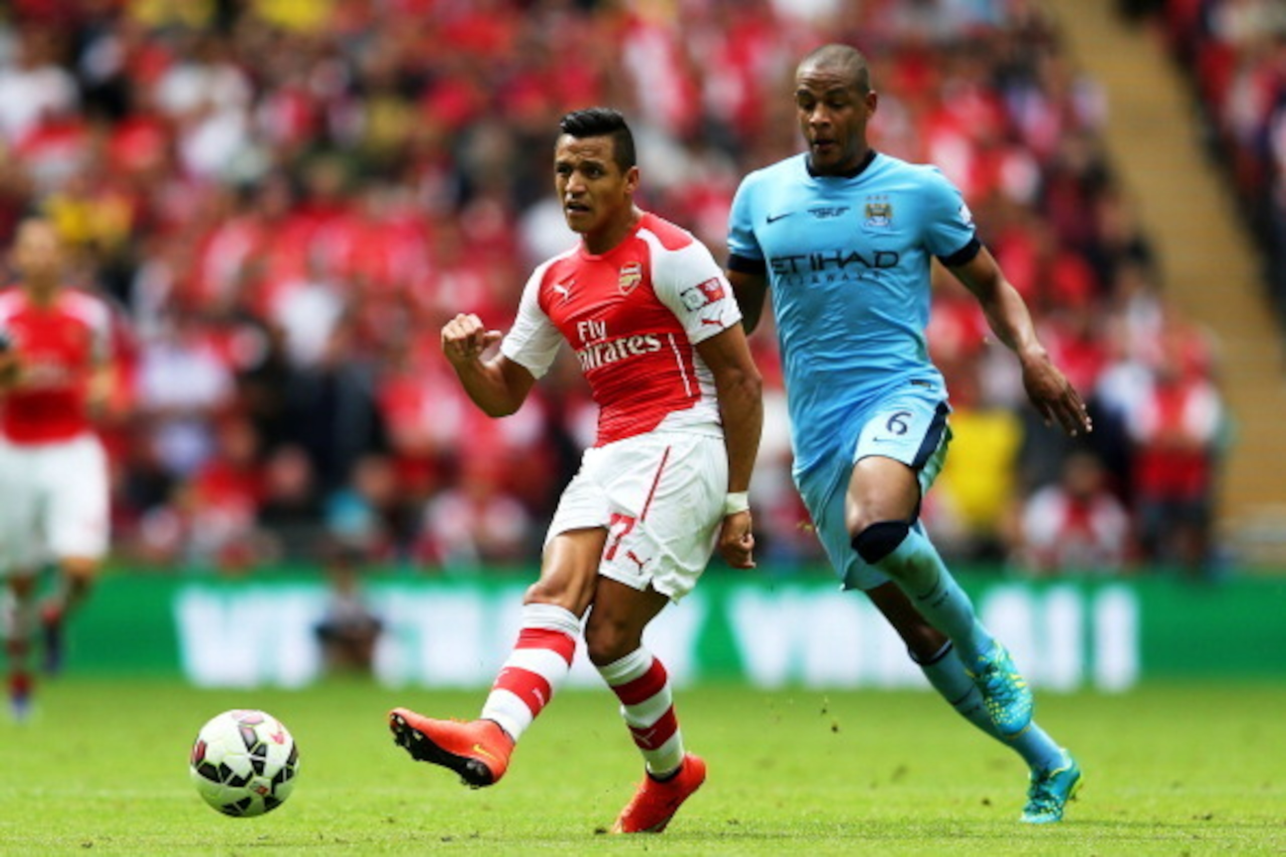 LONDON, ENGLAND - AUGUST 10: Alexis Sanchez of Arsenal in action against Fernando of Manchester City during the FA Community Shield match between Manchester City and Arsenal at Wembley Stadium on August 10, 2014 in London, England. (Photo by Clive Mason/ LONDON, ENGLAND - AUGUST 10: Alexis Sanchez of Arsenal in action against Fernando of Manchester City during the FA Community Shield match between Manchester City and Arsenal at Wembley Stadium on August 10, 2014 in London, England. (Photo by Clive Mason/