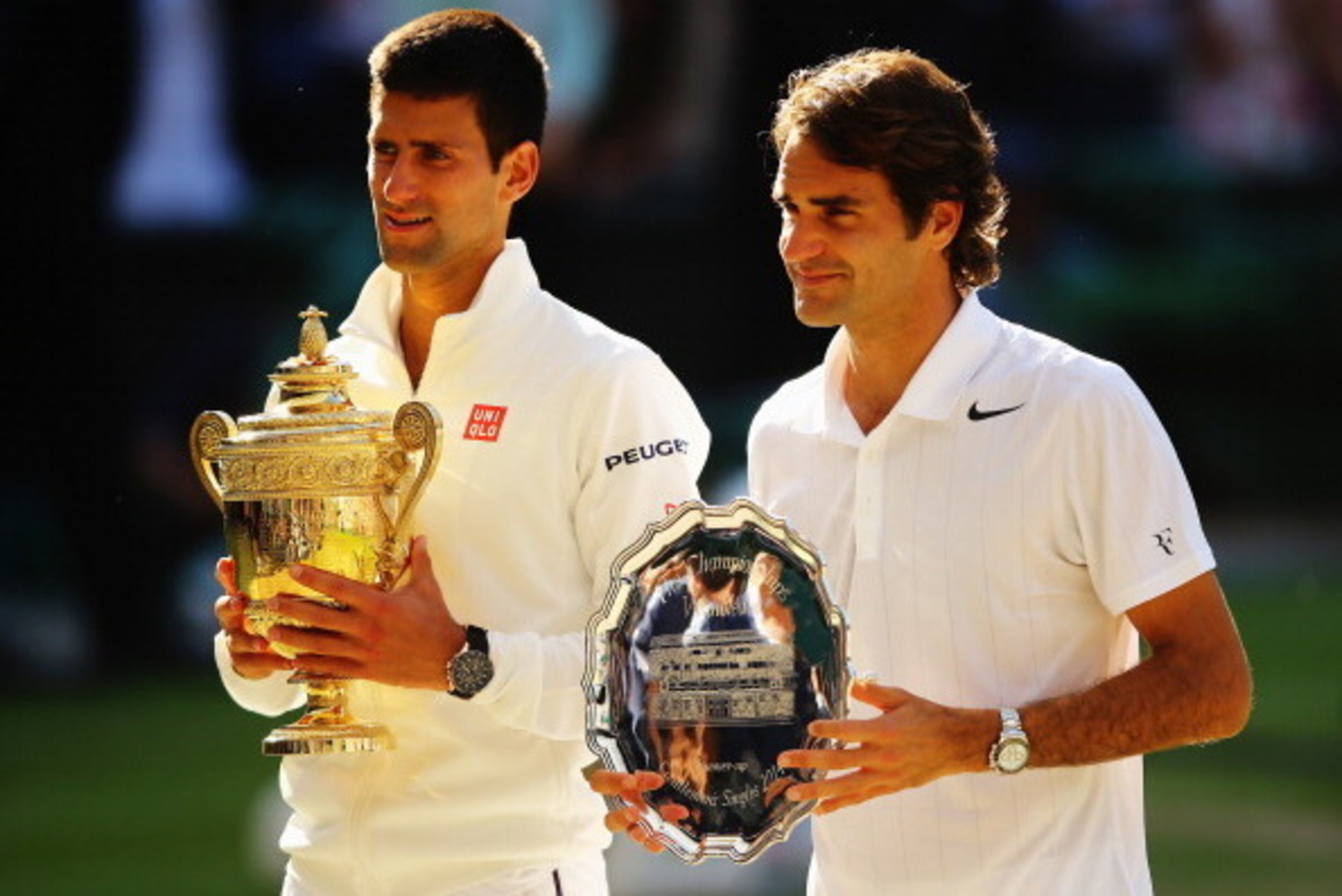 LONDON, ENGLAND - JULY 06:  Novak Djokovic of Serbia poses with the Gentlemen's Singles Trophy next to Roger Federer of Switzerland following his victory in the Gentlemen's Singles Final match on day thirteen of the Wimbledon Lawn Tennis Championships at 