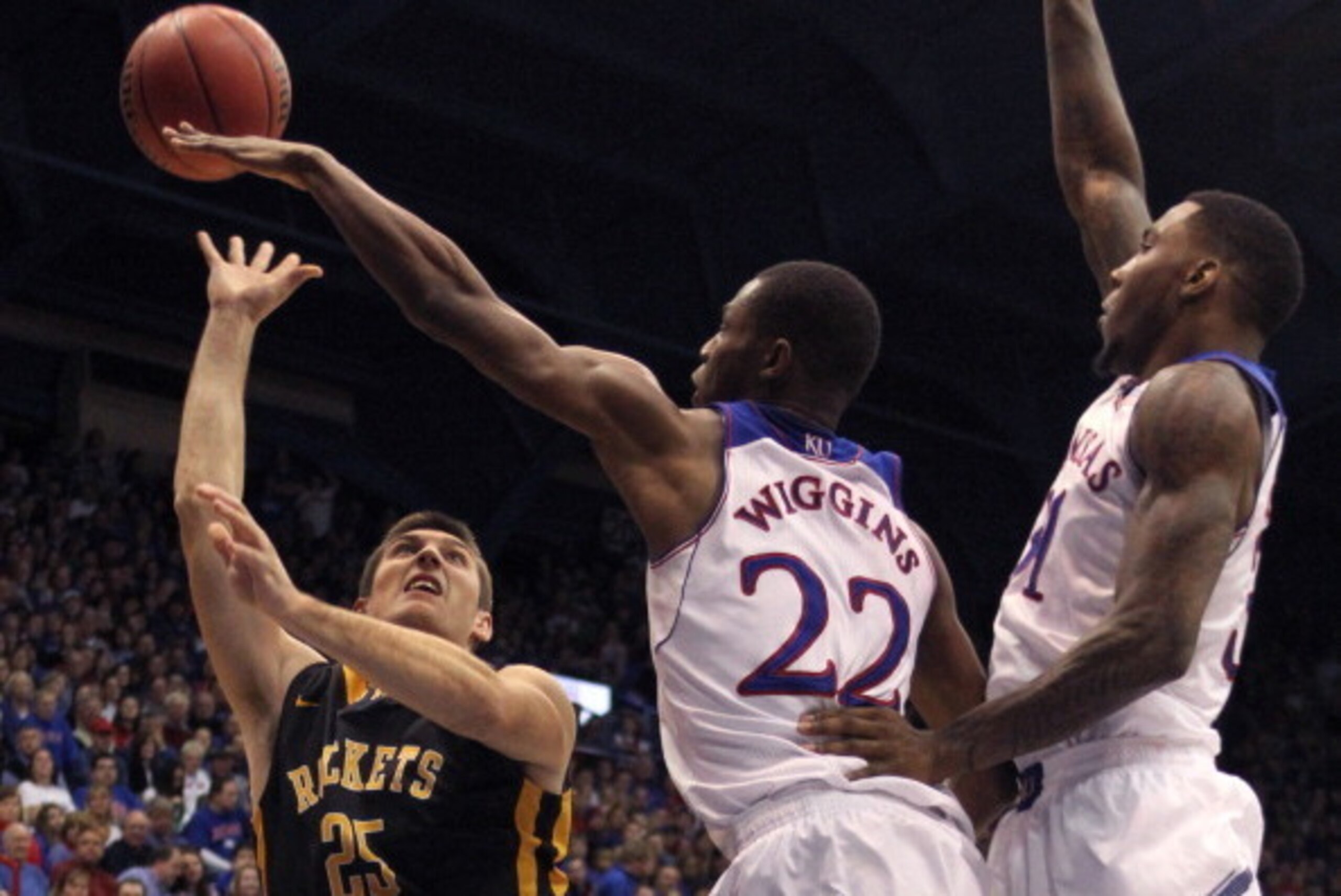LAWRENCE, KS - DECEMBER 30:  Jordan Lauf #25 of the Toledo Rockets shoots over Andrew Wiggins #22 and Jamari Traylor #31 of the Kansas Jayhawks in the second half at Allen Fieldhouse on December 30, 2013 in Lawrence, Kansas. (Photo by Ed Zurga/Getty Image