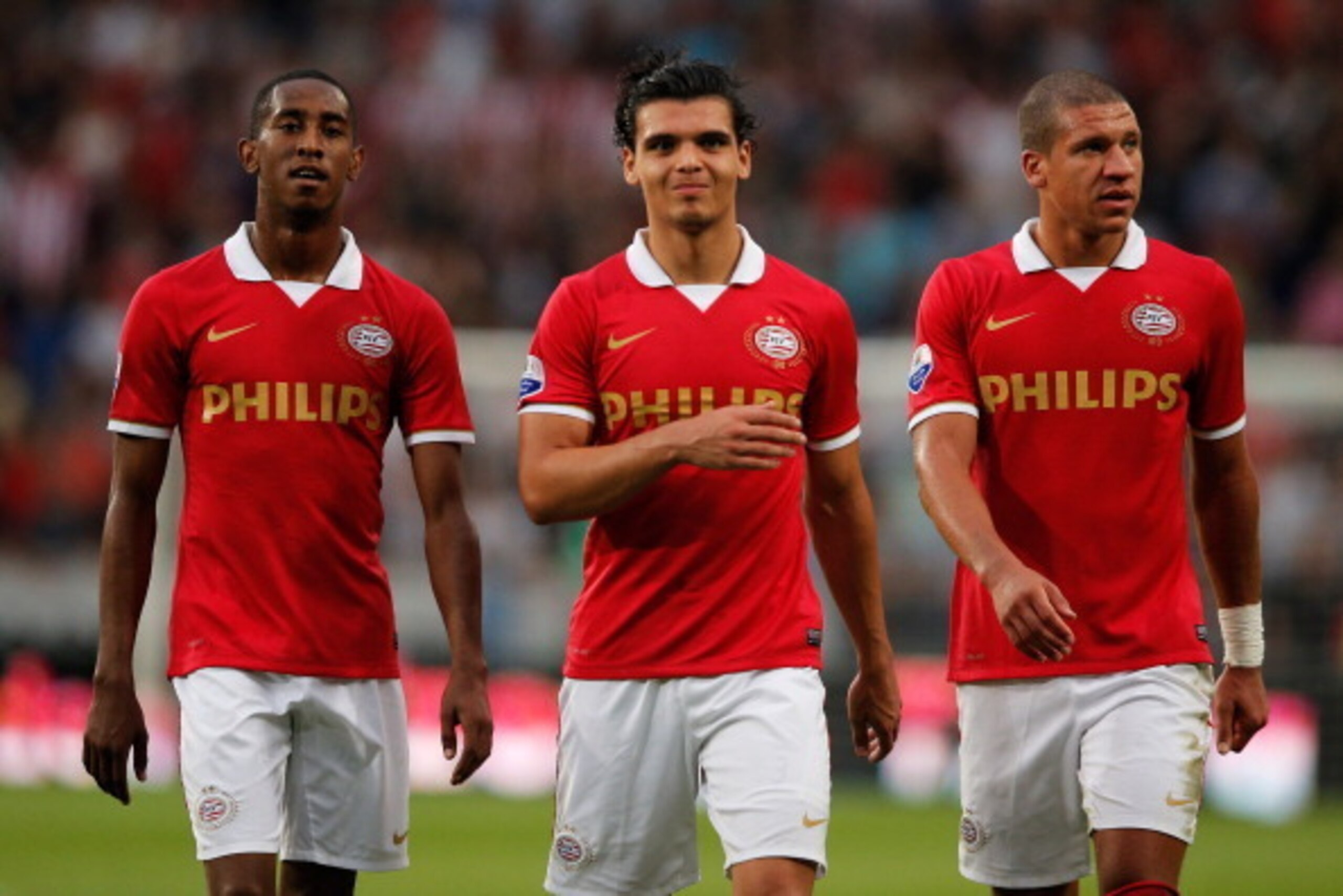 EINDHOVEN, NETHERLANDS - AUGUST 17:  (L-R)  Joshua Brenet, Jeffrey Bruma and Karim Rekik walk over to congratulate Memphis Depay (not in frame) of PSV after he scores the third goal of the game during the Eredivisie match between PSV Eindhoven and Go Ahea