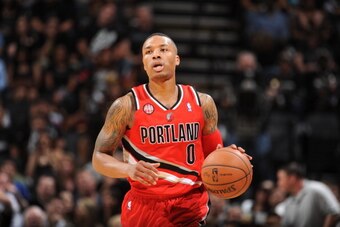 SAN ANTONIO, TX - MAY 14: Damian Lillard #0 of the Portland Trail Blazers moves the ball up-court against the San Antonio Spurs in Game Five of the Western Conference Semifinals during the 2014 NBA Playoffs on May 14, 2014 at the AT&T Center in San Antoni