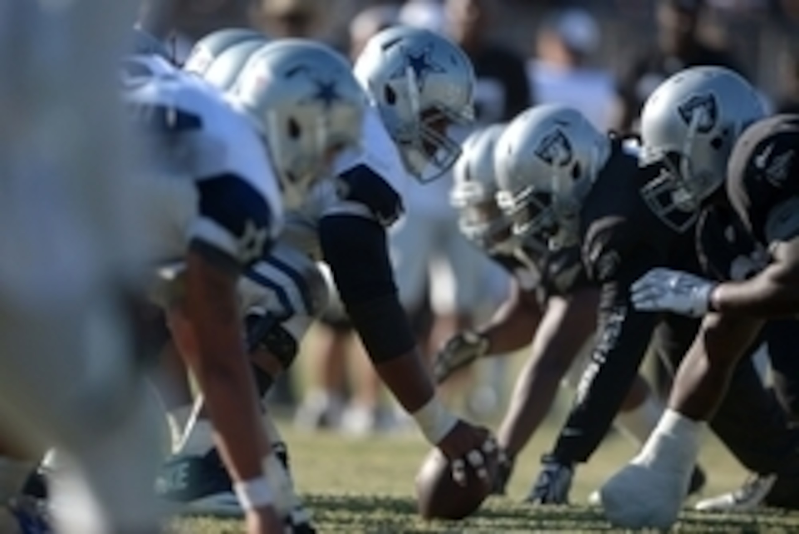 Aug 12, 2014; Oxnard, CA, USA; General view of the line of scrimmage as Dallas Cowboys center Mackenzy Bernadeau snaps the ball at scrimmage against the Oakland Raiders at River Ridge Fields. Mandatory Credit: Kirby Lee-USA TODAY Sports