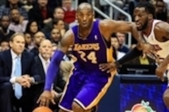 Dec 16, 2013; Atlanta, GA, USA; Los Angeles Lakers shooting guard Kobe Bryant (24) drives to the basket past Atlanta Hawks small forward DeMarre Carroll (5) in the first half at Philips Arena. Mandatory Credit: Daniel Shirey-USA TODAY Sports
