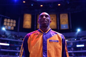 LOS ANGELES, CA - DECEMBER 10: Kobe Bryant #24 of the Los Angeles Lakers looks on during the performance of the National Anthem before facing the Phoenix Suns at Staples Center on December 10, 2013 in Los Angeles, California. NOTE TO USER: User expressly 