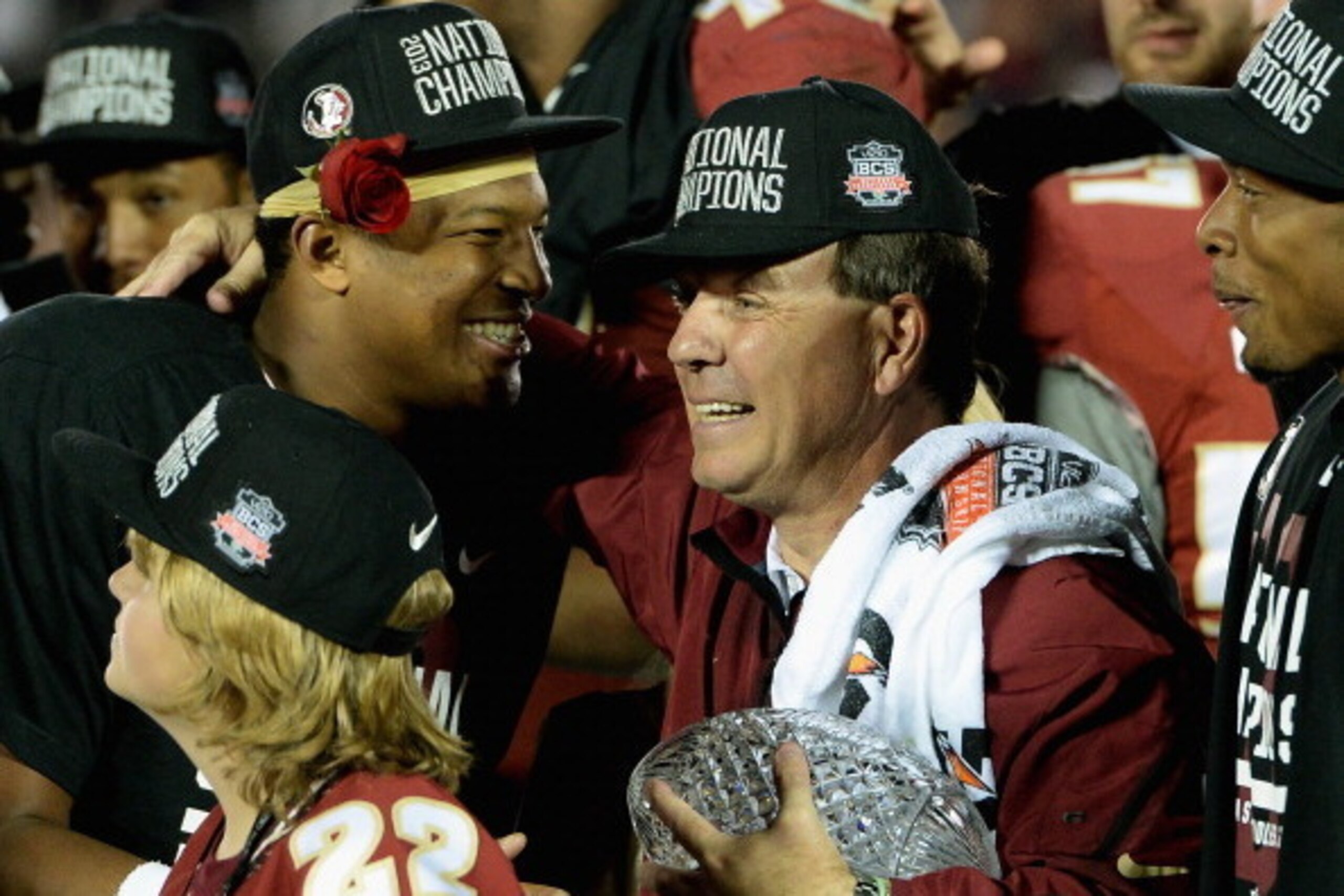 PASADENA, CA - JANUARY 06:  Florida State Seminoles head coach Jimbo Fisher (R) holds the Coaches' Trophy as quarterback Jameis Winston (L) #5 looks on after defeating the Auburn Tigers 34-31 in the 2014 Vizio BCS National Championship Game at the Rose Bo