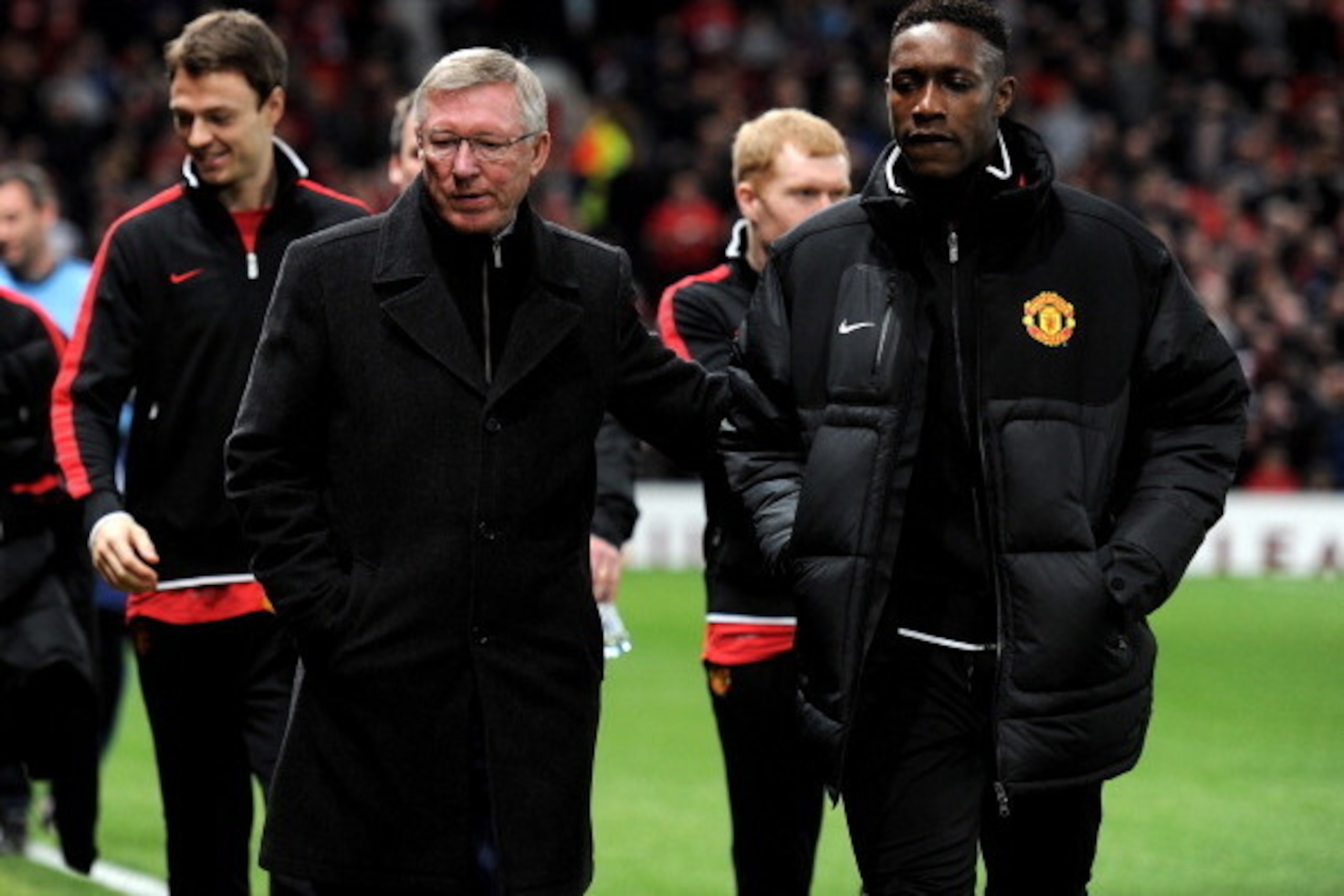 MANCHESTER, ENGLAND - FEBRUARY 23:   Manchester United Manager Sir Alex Ferguson walks to the bench with Danny Welbeck prior to the UEFA Europa League Round of 32 second leg match between Manchester United and AFC Ajax at Old Trafford on February 23, 2012