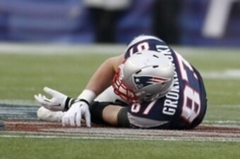 Dec 8, 2013; Foxborough, MA, USA; New England Patriots tight end Rob Gronkowski (87) lies on he ground after getting injured by a Cleveland Browns player during the third quarter at Gillette Stadium. Mandatory Credit: Stew Milne-USA TODAY Sports
