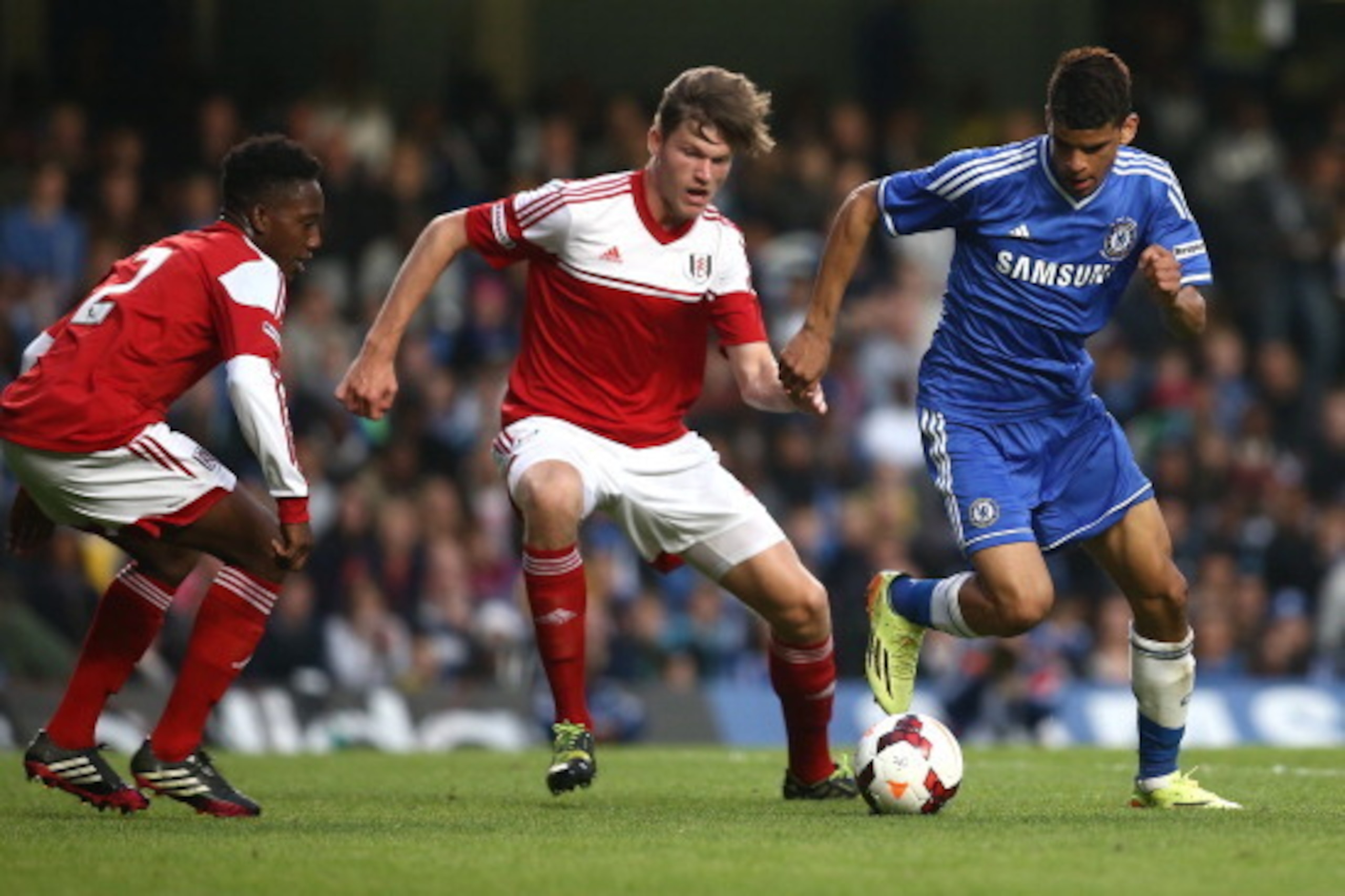 LONDON, ENGLAND - MAY 05: Dominic Solanke of Chelsea breaks away from Fulham's Cameron Burgess and Ryheem Sheckleford during the FA Youth Cup Final Second Leg match between Chelsea and Fulham at Stamford Bridge on May 05, 2014 in London, England. (Photo b