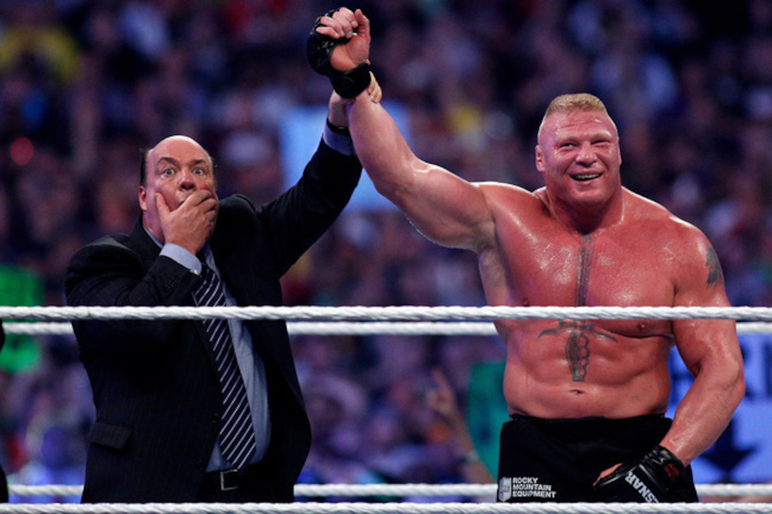 Paul Heyman raises the hand of Brock Lesnar at WrestleMania XXX.