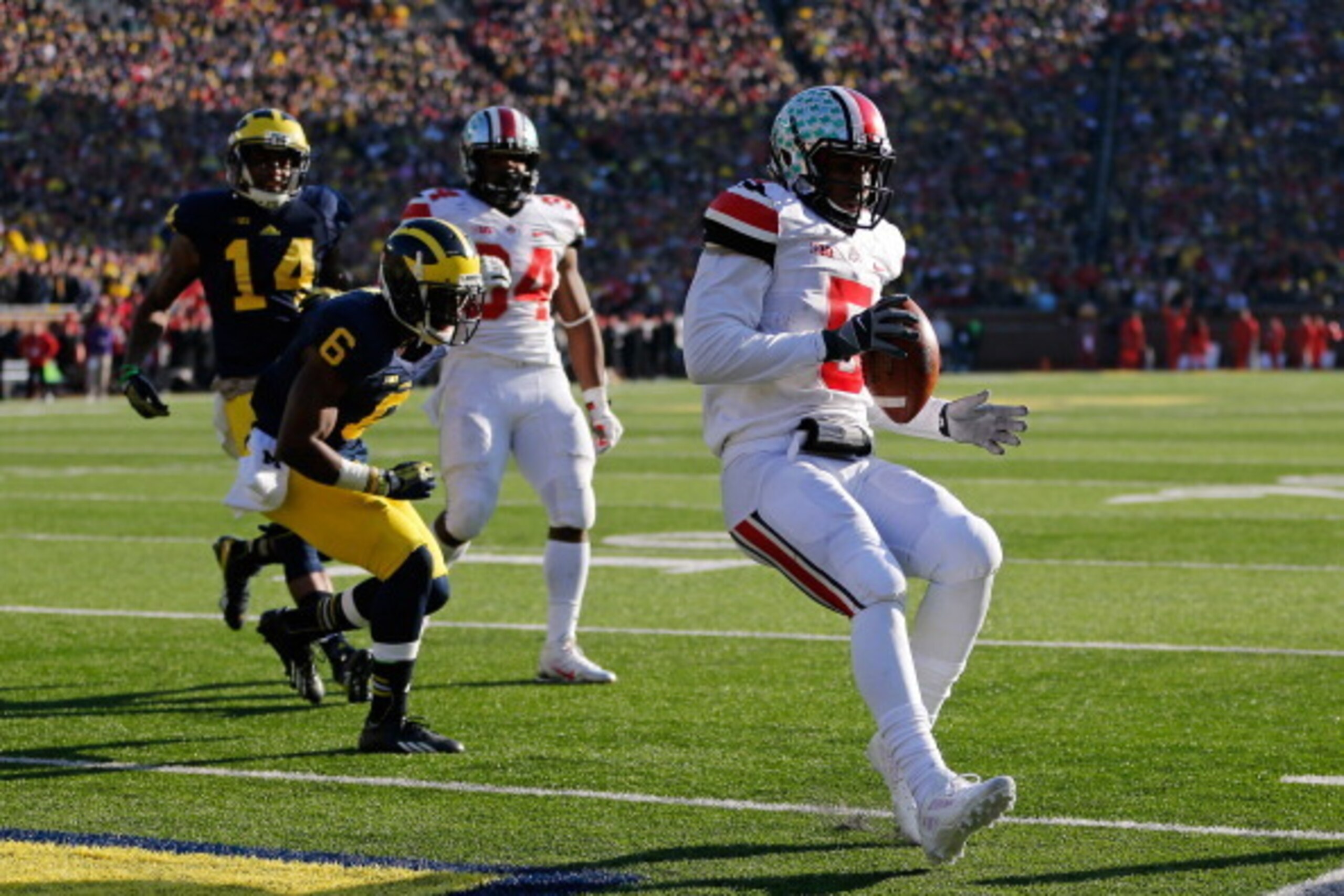 ANN ARBOR, MI - NOVEMBER 30: Quarterback Braxton Miller #5 of the Ohio State Buckeyes scores a touchdown in the third quarter against the Michigan Wolverines during a game at Michigan Stadium on November 30, 2013 in Ann Arbor, Michigan.  (Photo by Gregory