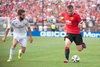 Aug 2, 2014; Ann Arbor, MI, USA; Manchester United defender Luke Shaw (28) and Real Madrid defender Daniel Carvajal (15) during the second half at Michigan Stadium. Mandatory Credit: Tim Fuller-USA TODAY Sports
