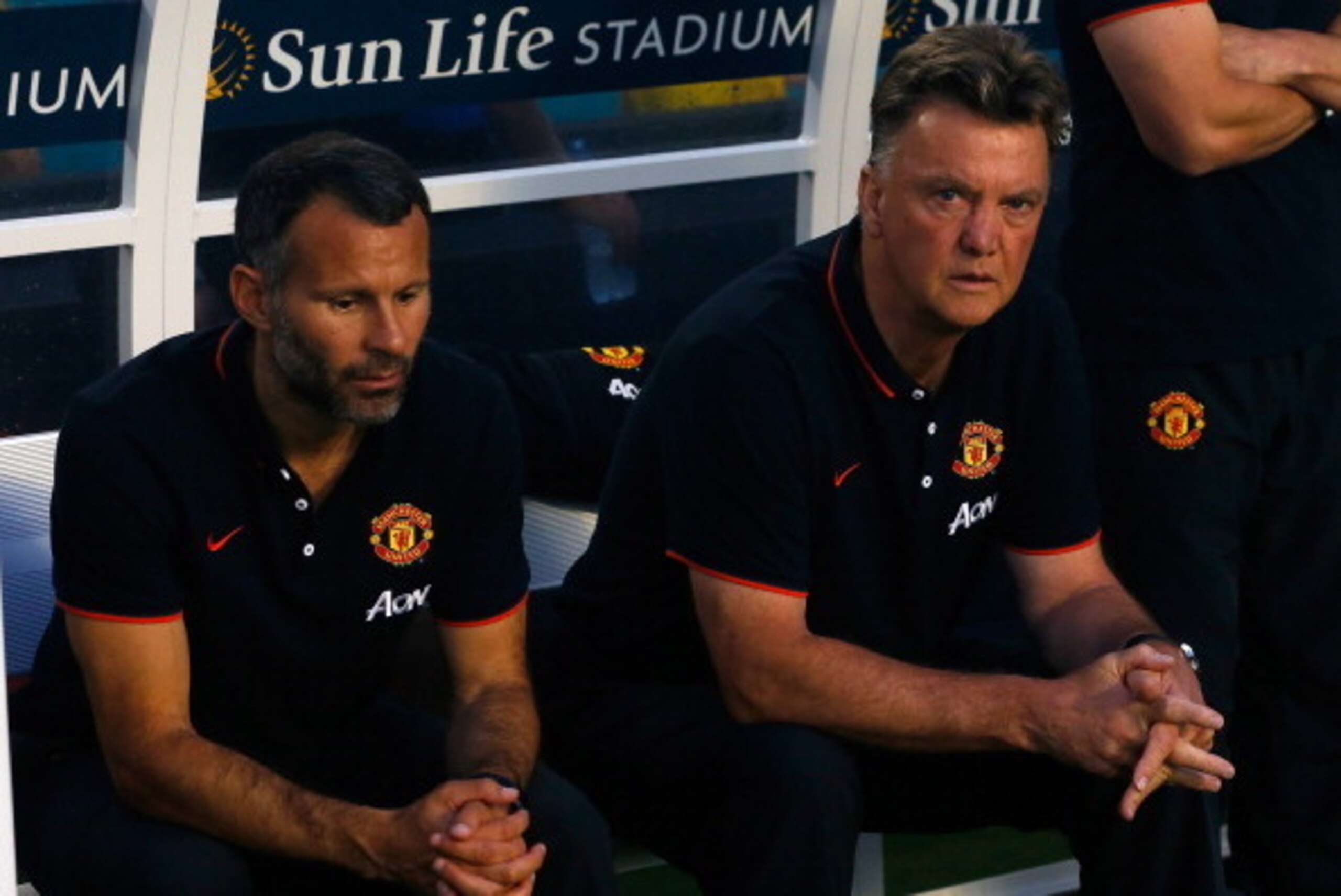 MIAMI GARDENS, FL - AUGUST 04: (L) Ryan Giggs and manager of Manchester United Louis Van Gaal sit on the bench prior to the game against Liverpool in the Guinness International Champions Cup 2014 Final at Sun Life Stadium on August 4, 2014 in Miami Garden