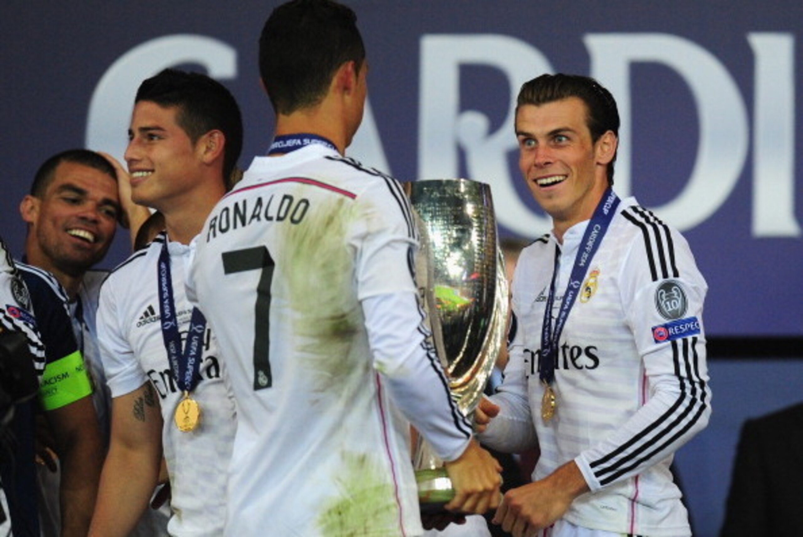 CARDIFF, WALES - AUGUST 12:  Real Madrid players James Rodriguez (l) Ronaldo and Gareth Bale (r) share a joke after the UEFA Super Cup match between Real Madrid and Sevilla FC  at Cardiff City Stadium on August 12, 2014 in Cardiff, Wales.  (Photo by Stu F