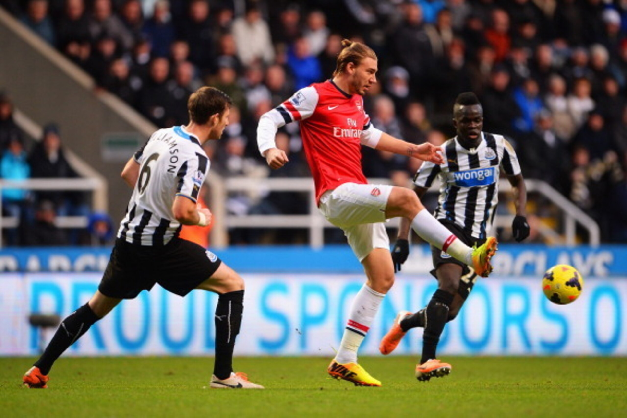 NEWCASTLE UPON TYNE, ENGLAND - DECEMBER 29: Nicklas Bendtner of Arsenal is closed down by Michael Williamson and Cheick Tiote of Newcastle United during the Barclays Premier League match between Newcastle United and Arsenal at St James' Park on December 2