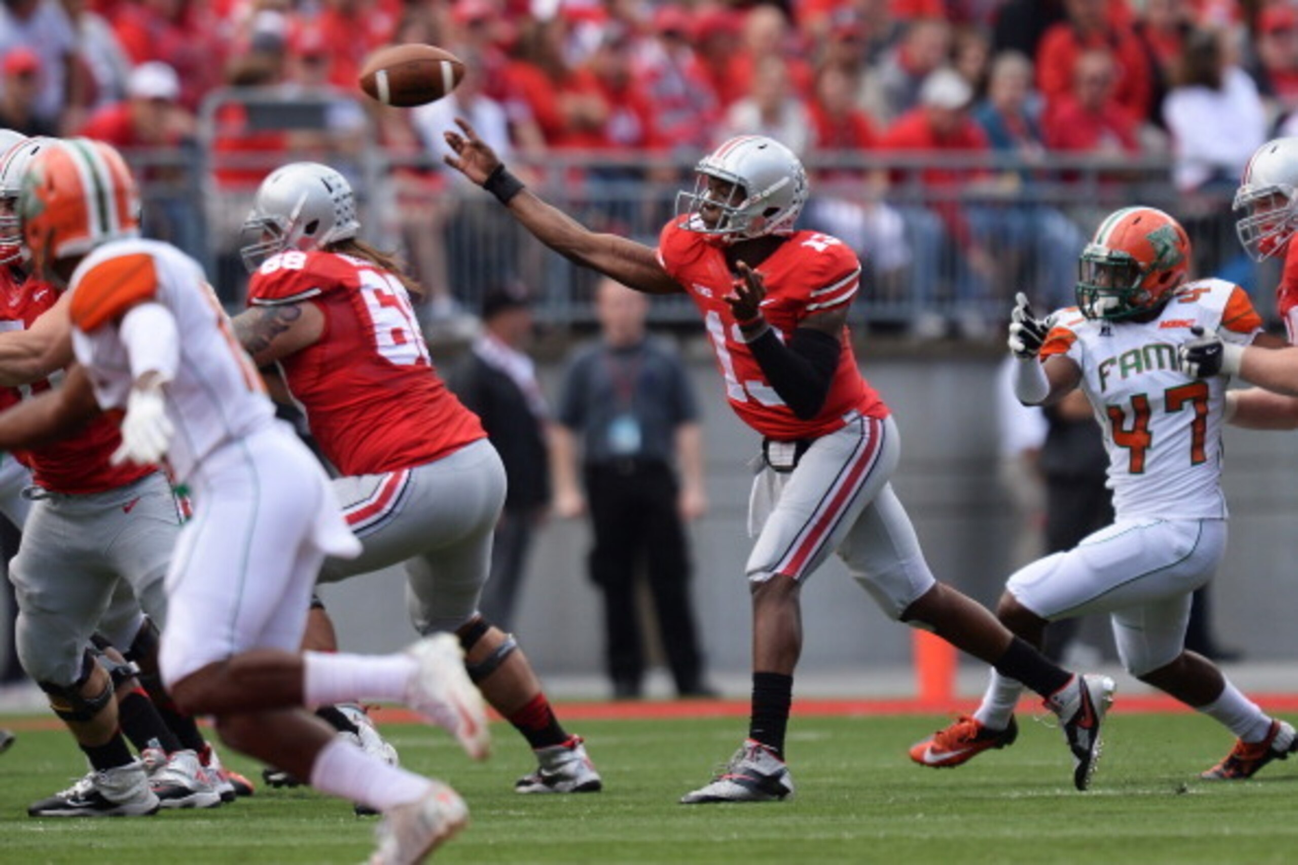 COLUMBUS, OH - SEPTEMBER 21:  Quarterback Kenny Guiton #13 of the Ohio State Buckeyes throws a pass in the first quarter against the Florida A&M Rattlers at Ohio Stadium on September 21, 2013 in Columbus, Ohio.  (Photo by Jamie Sabau/Getty Images)
