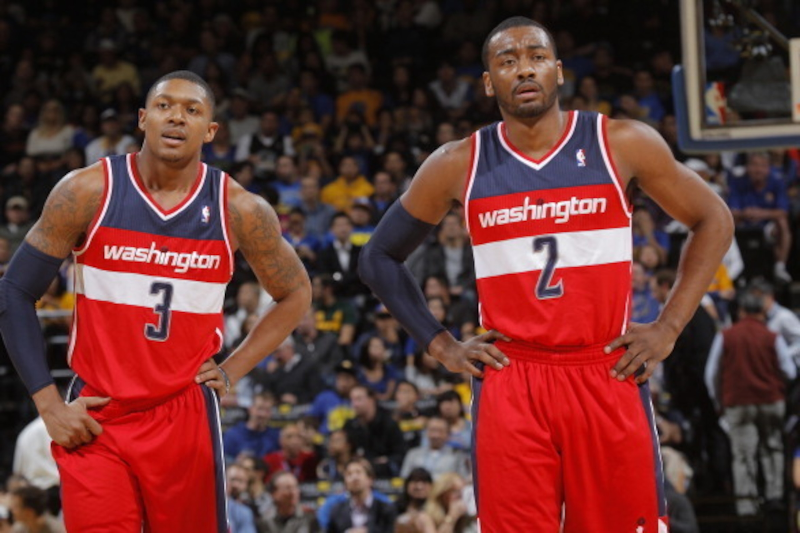 OAKLAND, CA - JANUARY 28: Bradley Beal #3 chats with teammate John Wall #2 of the Washington Wizards while facing the Golden State Warriors on January 28, 2014 at Oracle Arena in Oakland, California. NOTE TO USER: User expressly acknowledges and agrees th