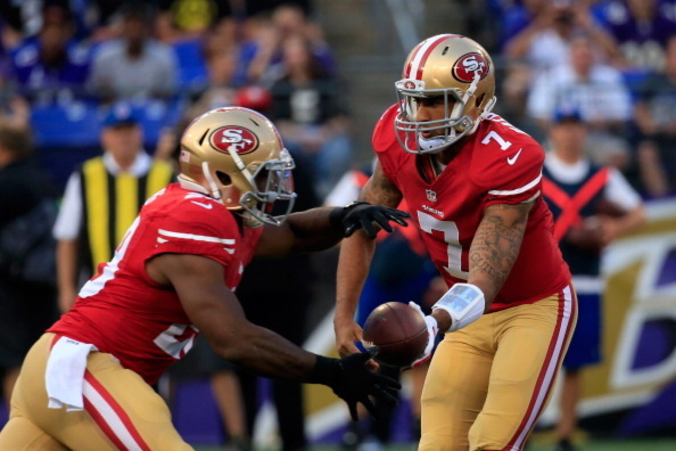 BALTIMORE, MD - AUGUST 07: Quarterback Colin Kaepernick #7 of the San Francisco 49ers hands the ball off to running back Carlos Hyde #28 during the first half of an NFL pre-season game against the Baltimore Ravens at M&T Bank Stadium on August 7, 2014 in BALTIMORE, MD - AUGUST 07: Quarterback Colin Kaepernick #7 of the San Francisco 49ers hands the ball off to running back Carlos Hyde #28 during the first half of an NFL pre-season game against the Baltimore Ravens at M&T Bank Stadium on August 7, 2014 in