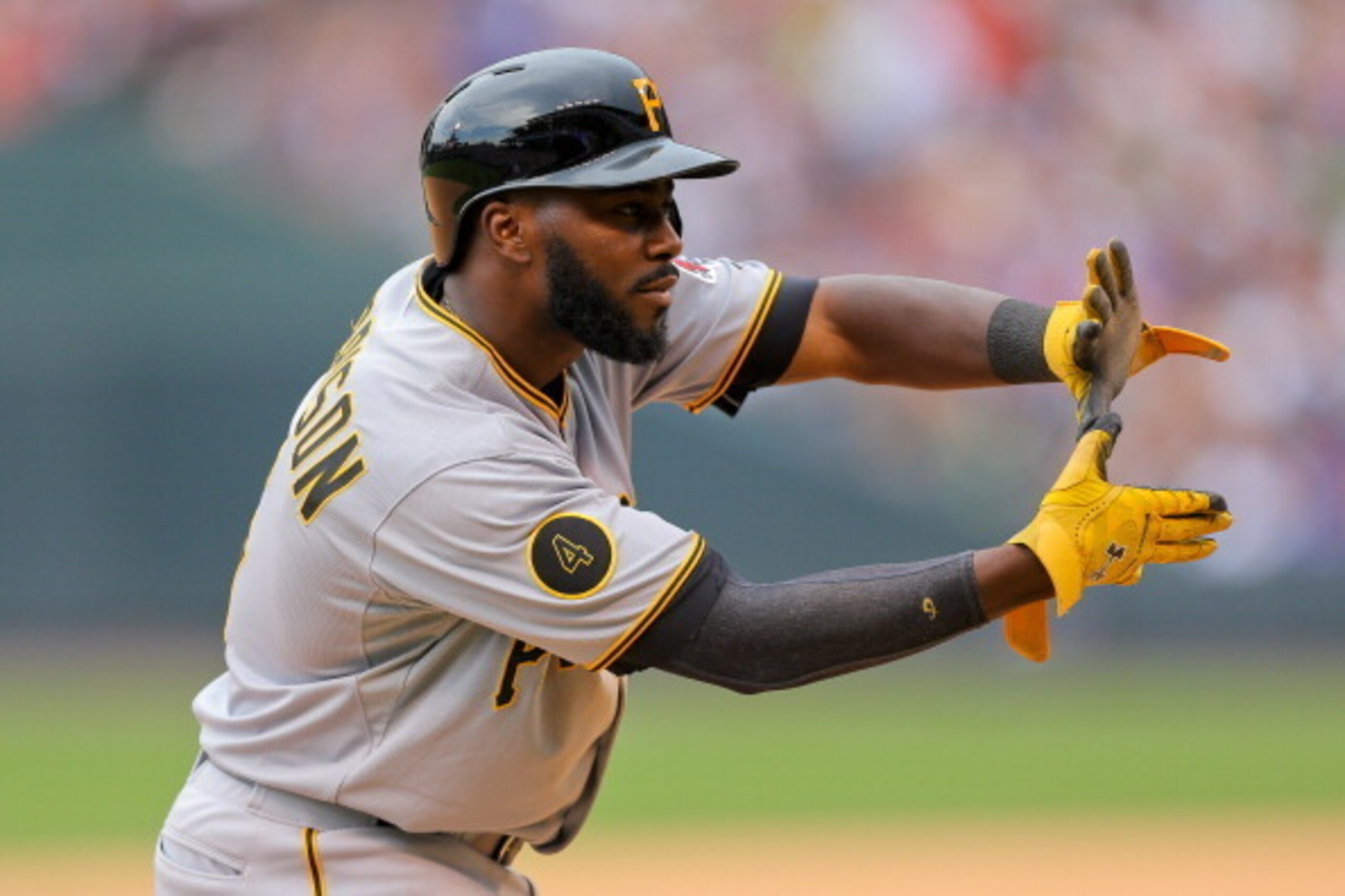 DENVER, CO - JULY 27:  Josh Harrison #5 of the Pittsburgh Pirates celebrates towards the dugout after stealing second base and advancing to third base in a run-down during the sixth inning against the Colorado Rockies at Coors Field on July 27, 2014 in De