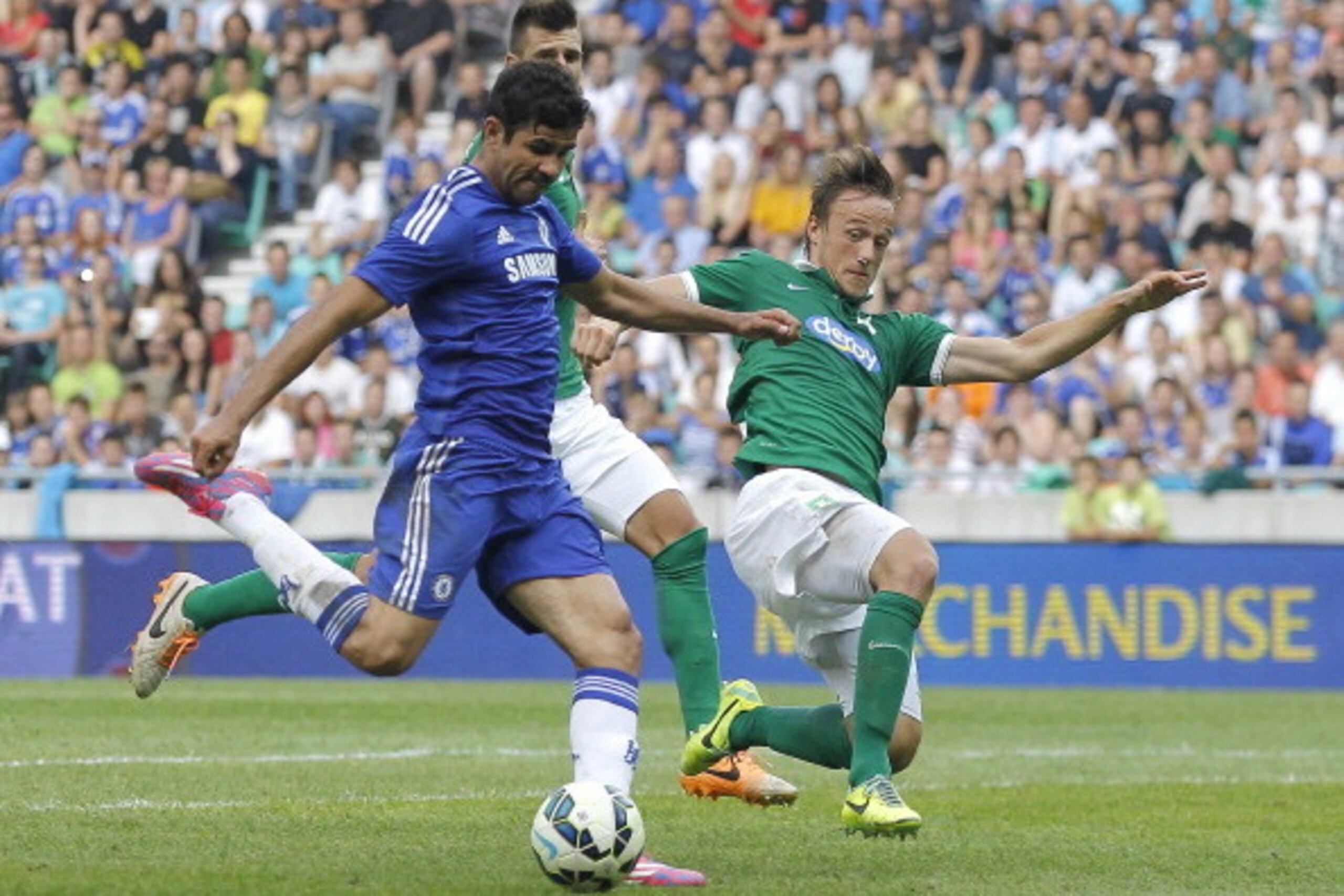 LJUBLJANA, SLOVENIA - JULY 27: Diego Costa (L) of Chelsea scores the goal near Antonio Mlinar Delamea (L) of FC Olimpija Ljubljana during the Pre Season Friendly match between FC Olimpija Ljubljana and Chelsea at Stozice stadium in Ljubljana, Slovenia on LJUBLJANA, SLOVENIA - JULY 27: Diego Costa (L) of Chelsea scores the goal near Antonio Mlinar Delamea (L) of FC Olimpija Ljubljana during the Pre Season Friendly match between FC Olimpija Ljubljana and Chelsea at Stozice stadium in Ljubljana, Slovenia on