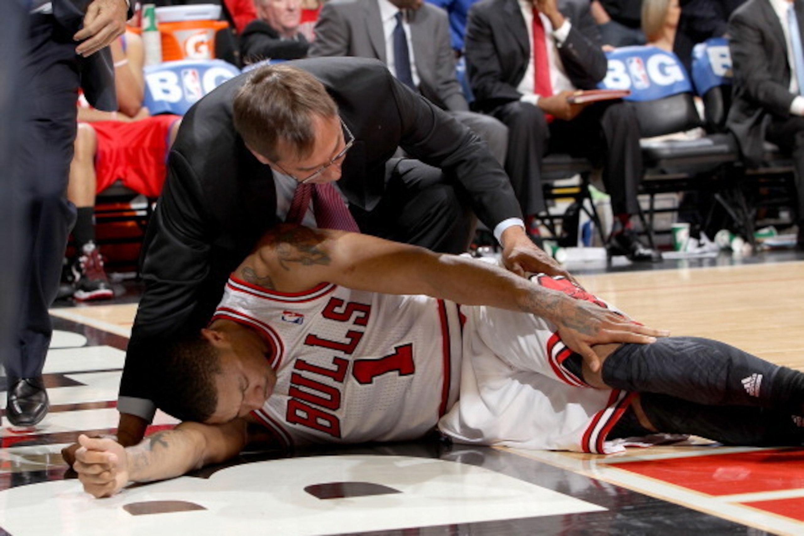 CHICAGO, IL - APRIL 28:  Chicago Bulls Head Athletic Trainer Fred Tedeschi assists Derrick Rose #1 after injuring his knee against the Philadelphia 76ers in Game One of the Eastern Conference Quarterfinals during the 2012 NBA Playoffs on April 28, 2012 at
