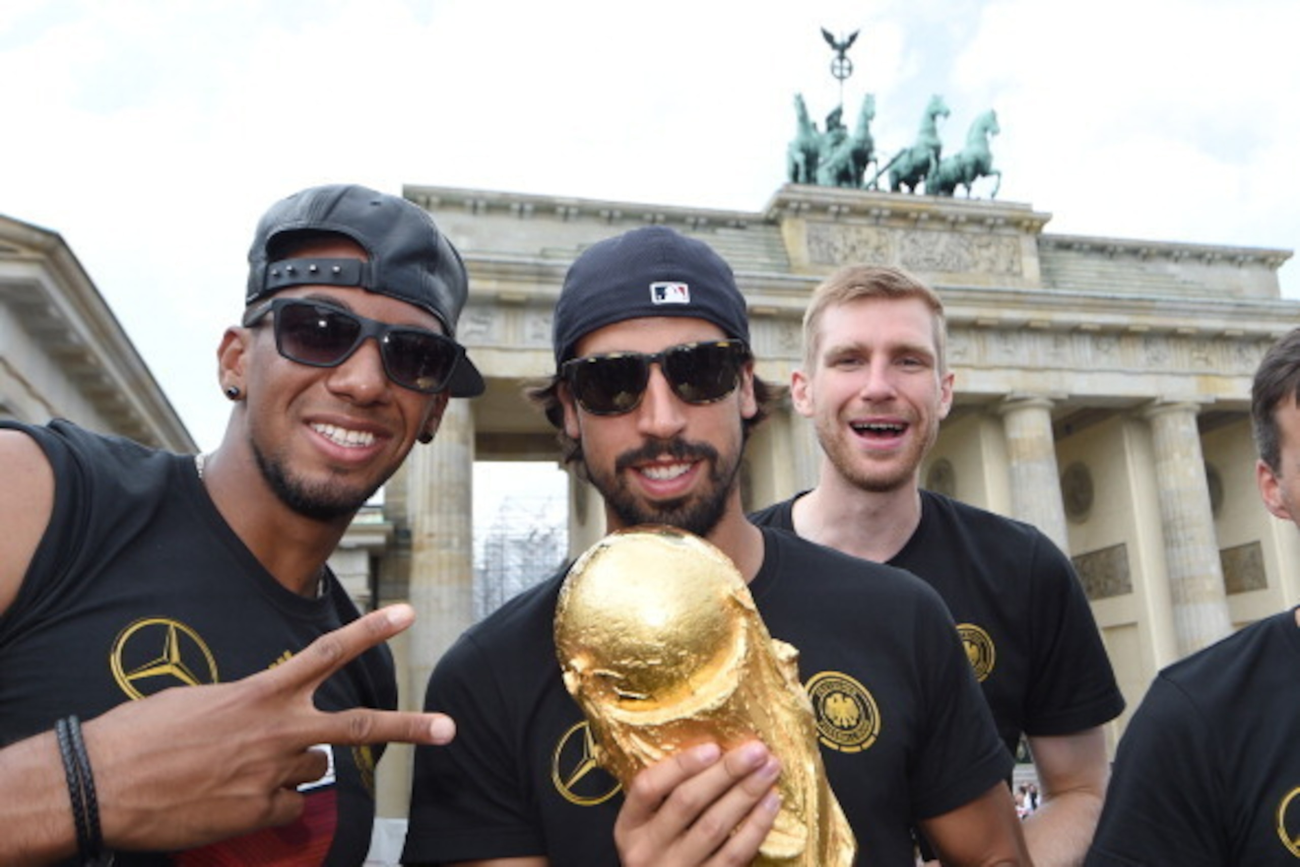 BERLIN, GERMANY - JULY 15: Jerome Boateng, Sami Khedira and  Per Mertersacker celebrate during the German team victory ceremony on July 15, 2014 in Berlin, Germany. Germany won the 2014 FIFA World Cup Brazil match against Argentina in Rio de Janeiro on Ju