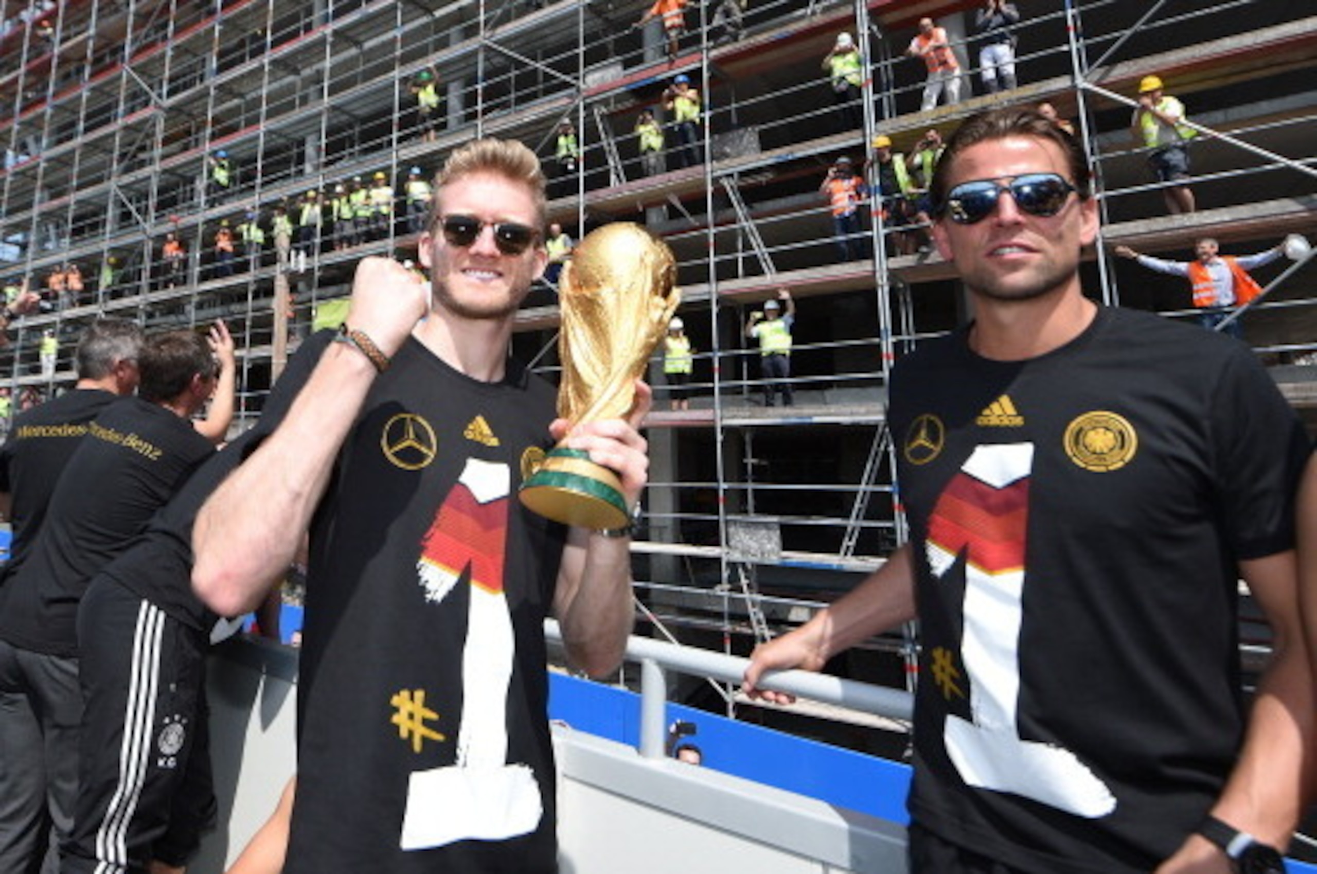 BERLIN, GERMANY - JULY 15: Roman Weidenfeller, Andre Schuerrle celebrate during the German team victory ceremony on July 15, 2014 in Berlin, Germany. Germany won the 2014 FIFA World Cup Brazil match against Argentina in Rio de Janeiro on July 13. (Photo BERLIN, GERMANY - JULY 15: Roman Weidenfeller, Andre Schuerrle celebrate during the German team victory ceremony on July 15, 2014 in Berlin, Germany. Germany won the 2014 FIFA World Cup Brazil match against Argentina in Rio de Janeiro on July 13. (Photo
