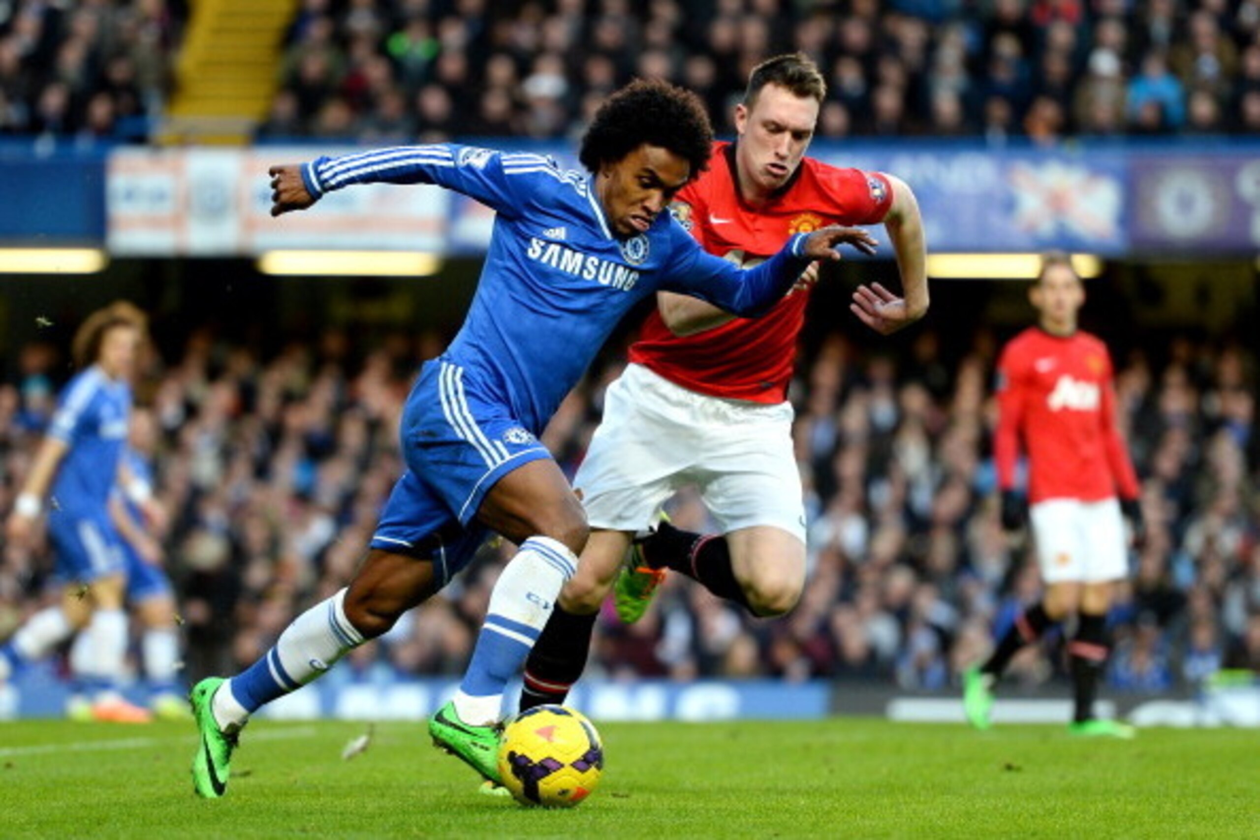 LONDON, ENGLAND - JANUARY 19:  Willian of Chelsea is closed down by Phil Jones of Manchester United during the Barclays Premier League match between Chelsea and Manchester United at Stamford Bridge on January 19, 2014 in London, England.  (Photo by Mike H