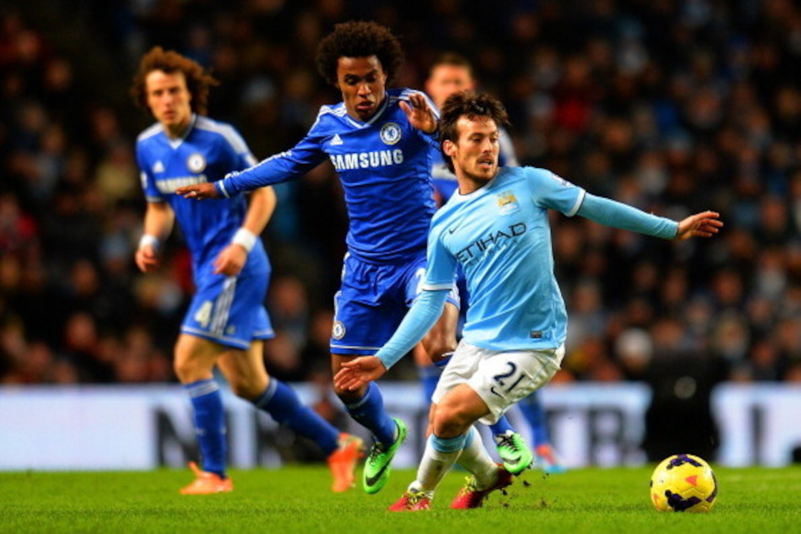MANCHESTER, ENGLAND - FEBRUARY 03: David Silva of Manchester City looks to break away from Willian of Chelsea during the Barclays Premier League match between Manchester City and Chelsea at Etihad Stadium on February 3, 2014 in Manchester, England.  (Phot