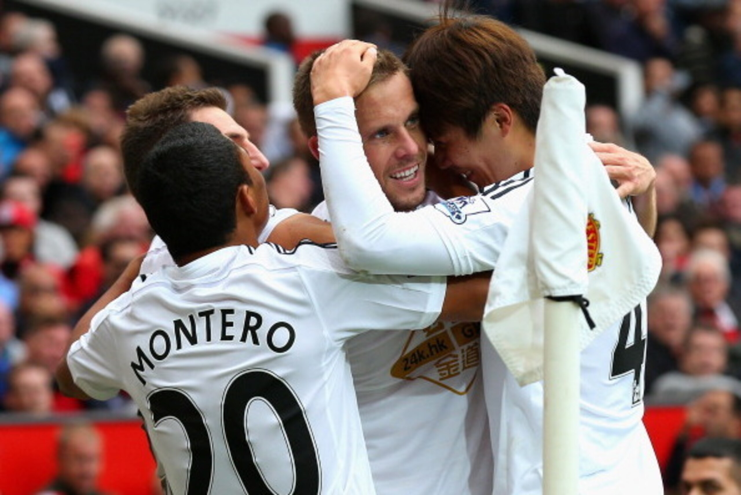 MANCHESTER, ENGLAND - AUGUST 16:  Gylfi Sigurdsson of Swansea City celebrates scoring his team's second goal with his team-mates during the Barclays Premier League match between Manchester United and Swansea City at Old Trafford on August 16, 2014 in Manc