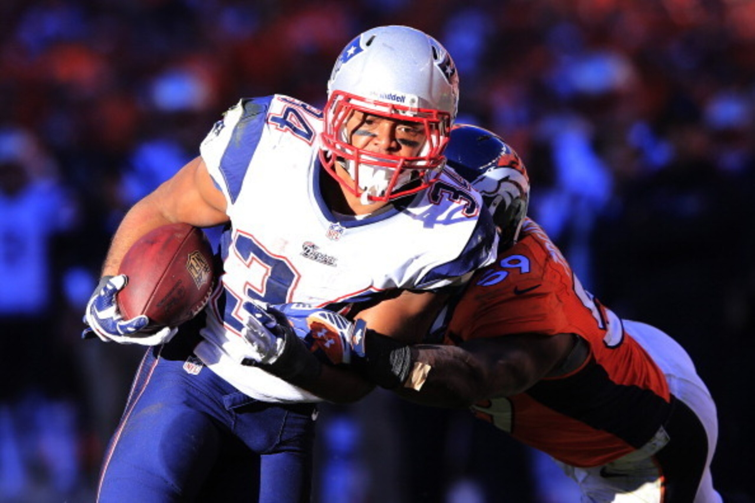 DENVER, CO - JANUARY 19:   Shane Vereen #34 of the New England Patriots runs the ball against Danny Trevathan #59 of the Denver Broncos during the AFC Championship game at Sports Authority Field at Mile High on January 19, 2014 in Denver, Colorado.  (Phot