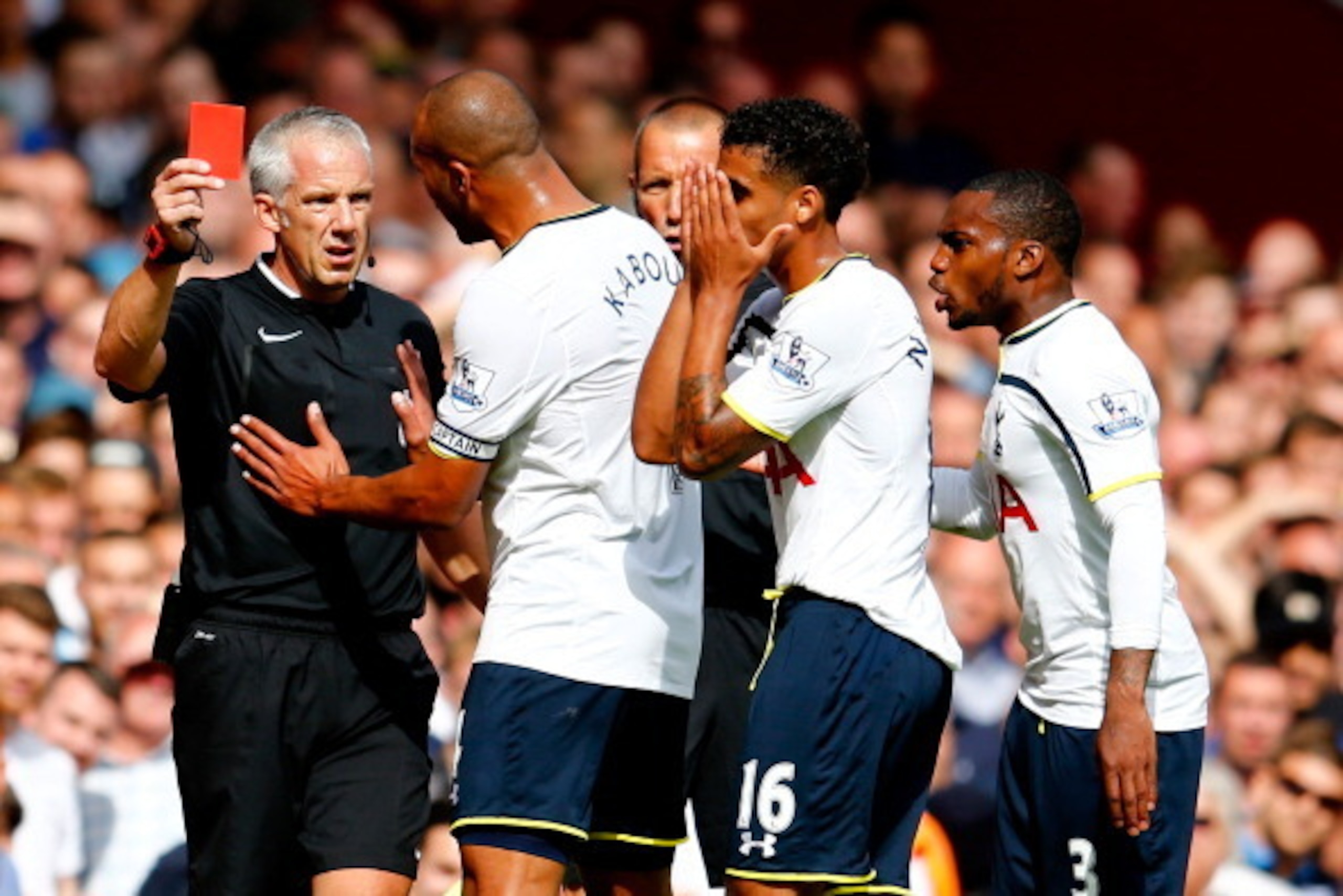 LONDON, ENGLAND - AUGUST 16:  Kyle Naughton of Spurs reacts after receiving a red card for handball as Younes Kaboul of Spurs remenstrates with referee Chris Foy during the Barclays Premier League match between West Ham United and Tottenham Hotspur at Bol