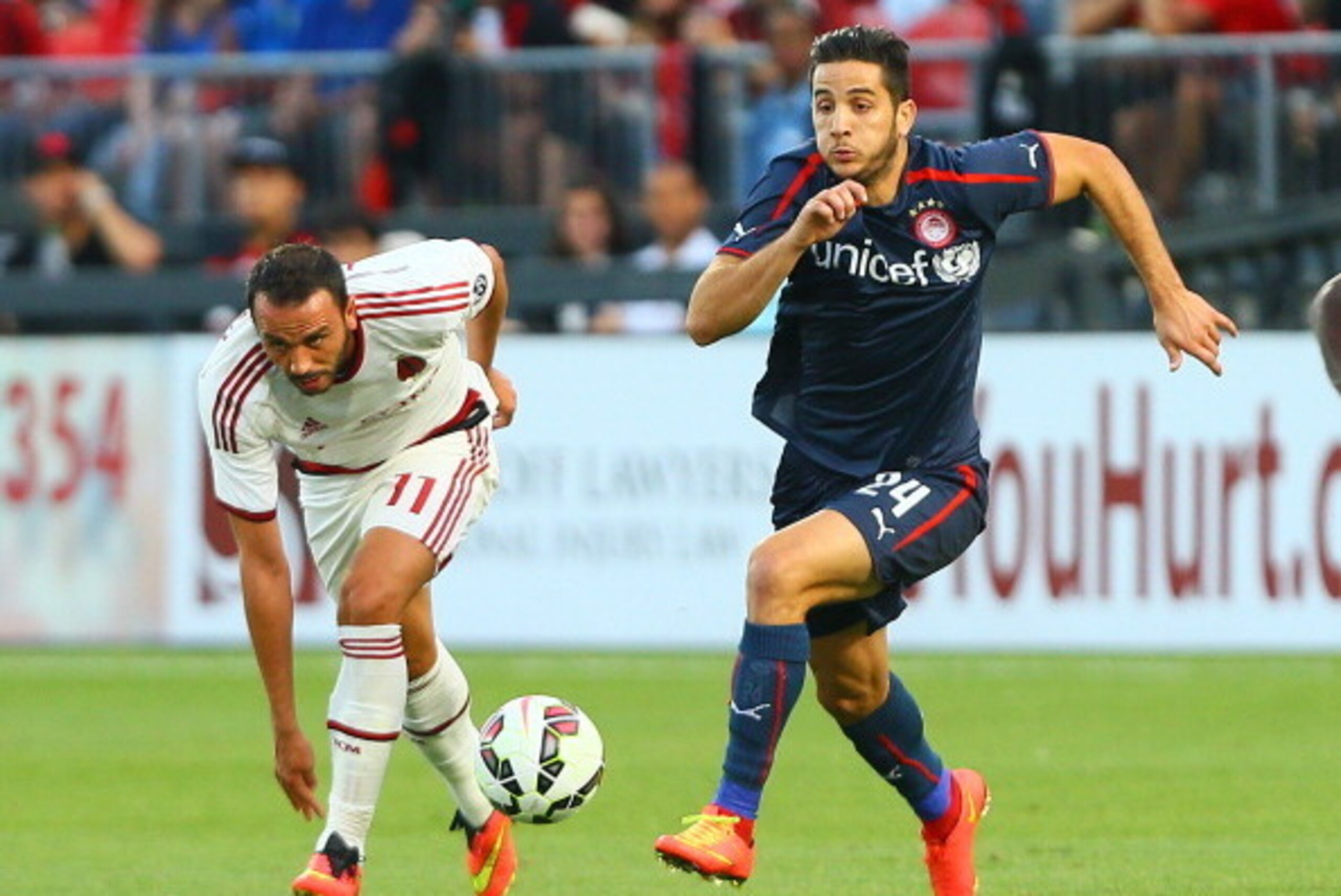 TORONTO, ON - JULY 24: Giampaolo Pazzini #11 of AC Milan chases the ball against Kostas Manolas #24 of Olympiacos FC during International Champions Cup 2014 action at BMO Field July 24, 2014 in Toronto, Ontario, Canada.  (Photo by Abelimages/Getty Images)