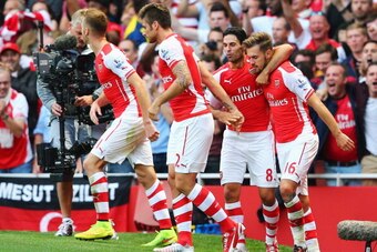 LONDON, ENGLAND - AUGUST 16: Aaron Ramsey (R) of Arsenal celebrates his goal with team mate Mikel Arteta during the Barclays Premier League match between Arsenal and Crystal Palace at Emirates Stadium on August 16, 2014 in London, England.  (Photo by Cliv