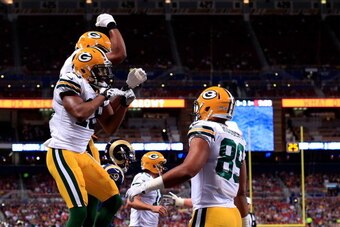 ST LOUIS, MO - AUGUST 16:  Randall Cobb #18 of the Green Bay Packers is congratulated by teammates after catch a touchdown pass during the preseason game against the St. Louis Rams at Edward Jones Dome on August 16, 2014 in St Louis, Missouri.  (Photo by