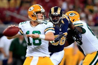 ST LOUIS, MO - AUGUST 16:  Defensive end Michael Sam #96 of the St. Louis Rams persues quarterback Scott Tolzien #16 of the Green Bay Packers during the preseason game at Edward Jones Dome on August 16, 2014 in St Louis, Missouri.  (Photo by Jamie Squire/
