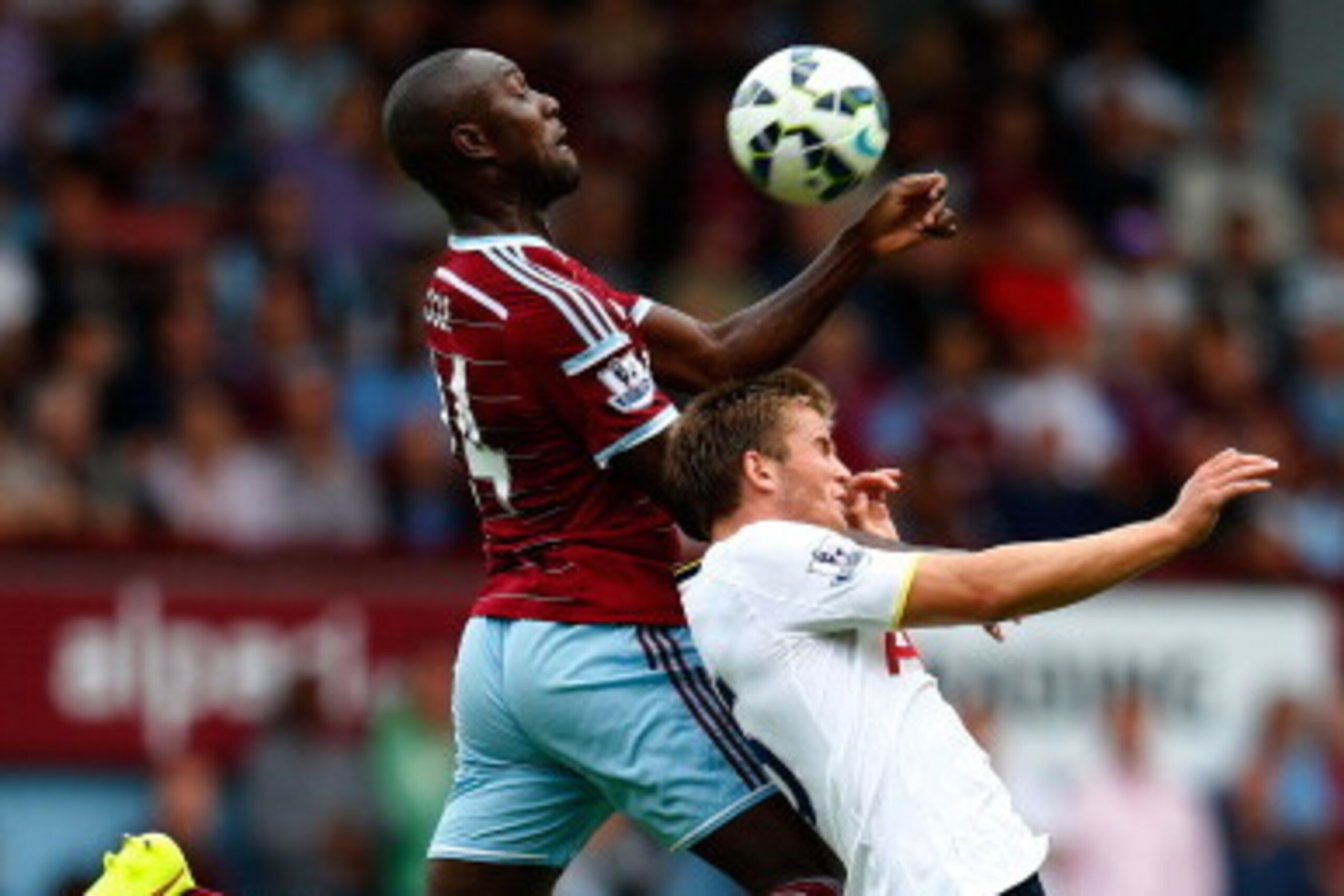 LONDON, ENGLAND - AUGUST 16:  Eric Dier of Tottenham Hotspur is beaten to the ball in the air by Carlton Cole of West Ham during the Barclays Premier League match between West Ham United and Tottenham Hotspur at Boleyn Ground on August 16, 2014 in London,