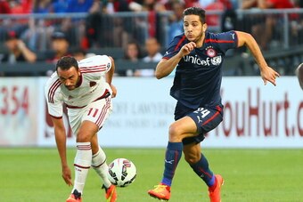 TORONTO, ON - JULY 24: Giampaolo Pazzini #11 of AC Milan chases the ball against Kostas Manolas #24 of Olympiacos FC during International Champions Cup 2014 action at BMO Field July 24, 2014 in Toronto, Ontario, Canada.  (Photo by Abelimages/Getty Images)