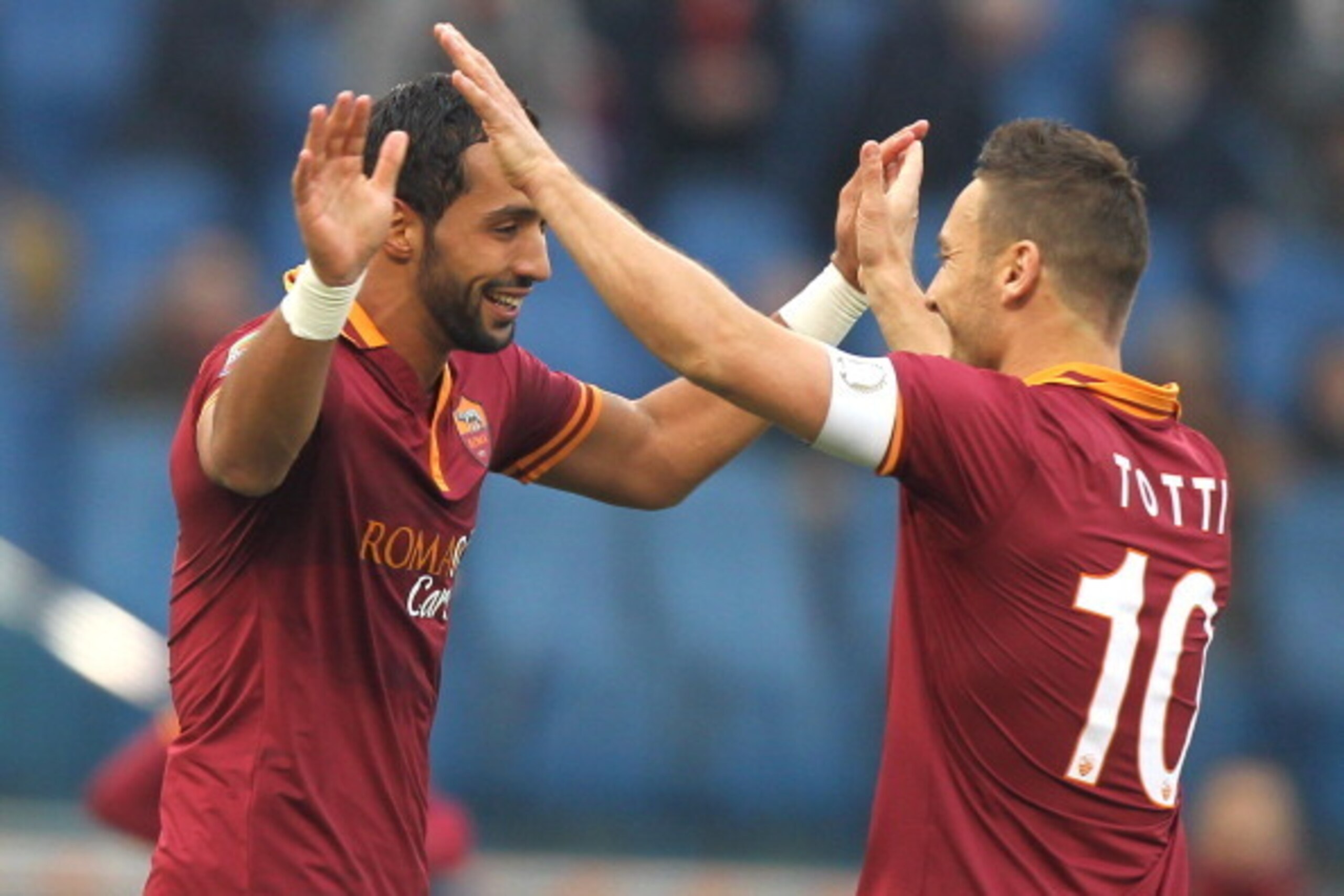 ROME, ITALY - JANUARY 12:  Mehdi Benatia (L) with his team-mate Francesco Totti of AS Roma celebrates after scoring their fourth during the Serie A match between AS Roma and Genoa CFC at Stadio Olimpico on January 12, 2014 in Rome, Italy.  (Photo by Paolo