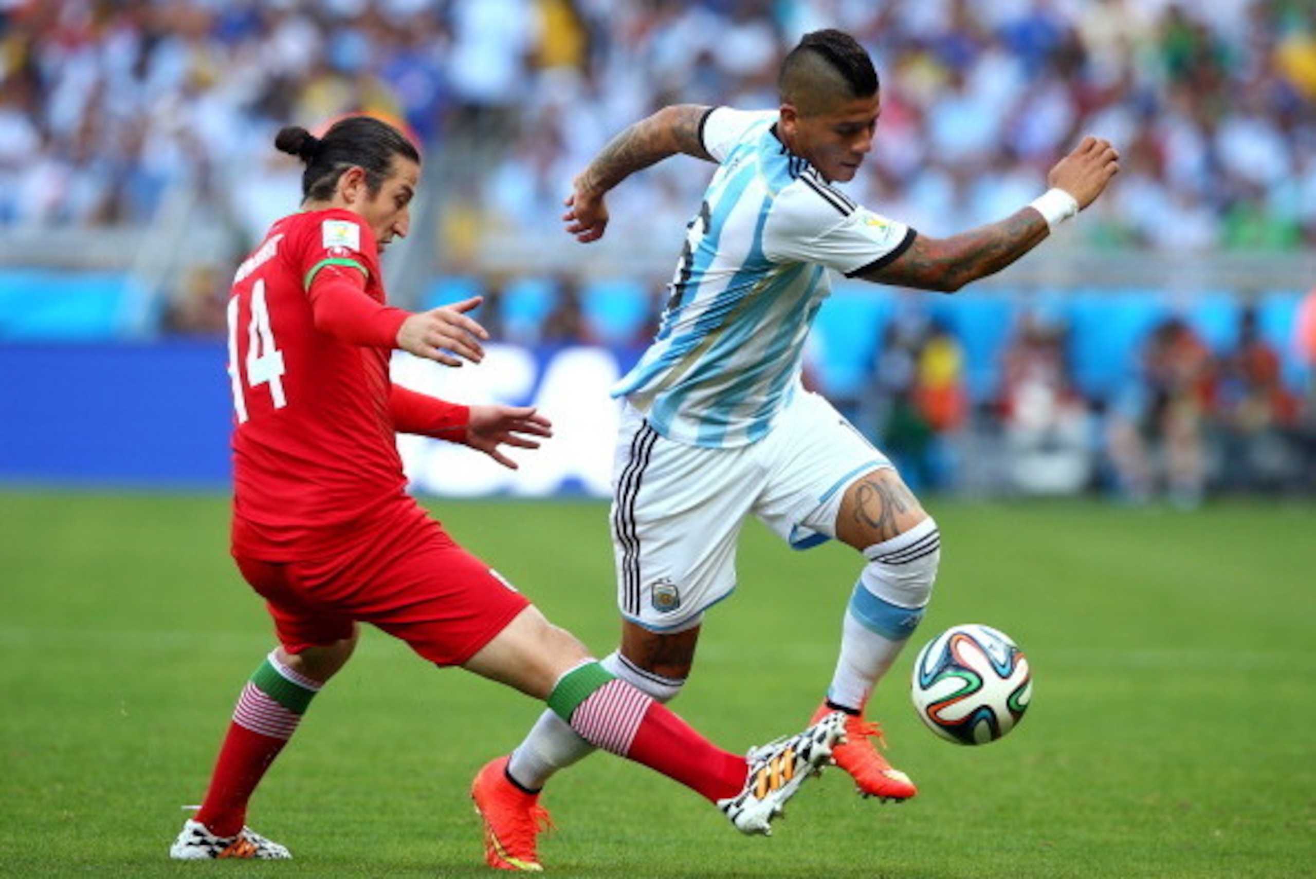 BELO HORIZONTE, BRAZIL - JUNE 21:  Andranik Teymourian of Iran tackles Marcos Rojo of Argentina  during the 2014 FIFA World Cup Brazil Group F match between Argentina and Iran at Estadio Mineirao on June 21, 2014 in Belo Horizonte, Brazil.  (Photo by Paul