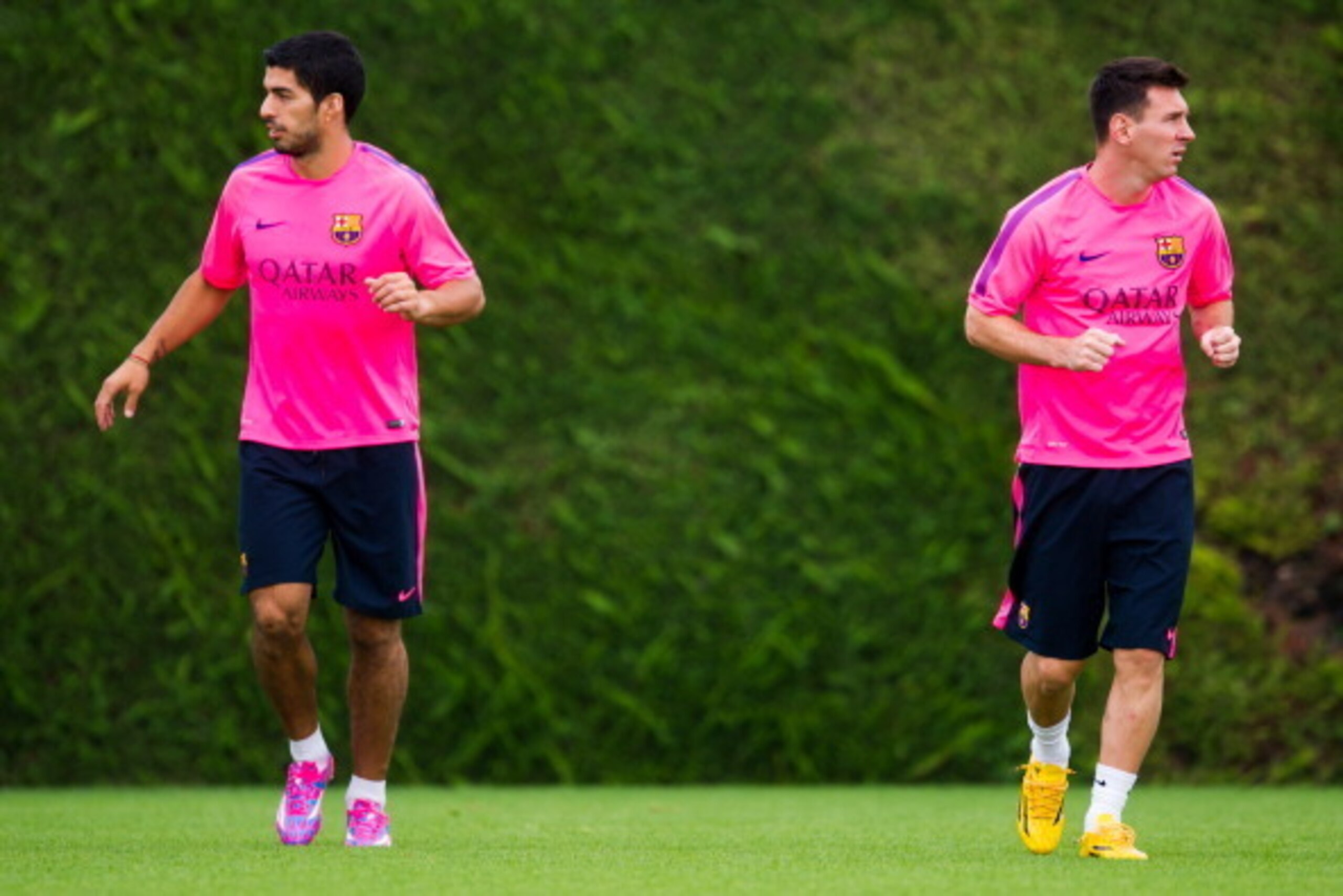 BARCELONA, SPAIN - AUGUST 17: Luis Suarez (L) and Lionel Messi (R) look on during a FC Barcelona training session at Ciutat Esportiva on August 17, 2014 in Barcelona, Spain.  (Photo by Alex Caparros/Getty Images)