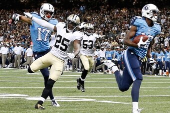 NEW ORLEANS, LA - AUGUST 15:  Justin Hunter #15 of the Tennessee Titans runs in a pass for a touchdown in front of Rafael Bush #25 of the New Orleans Saints during a preseason game at the Mercedes-Benz Superdome on August 15, 2014 in New Orleans, Louisian