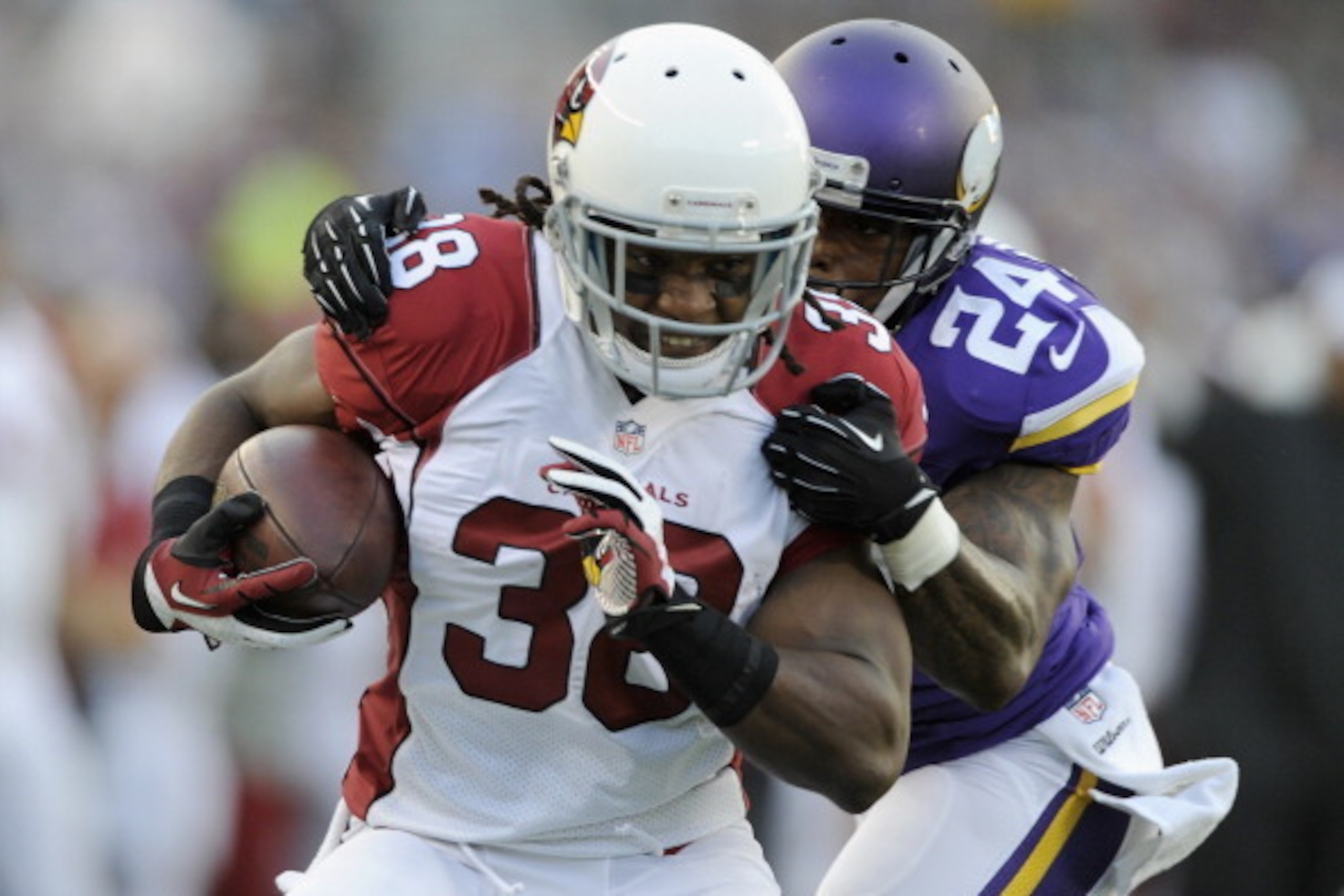 MINNEAPOLIS, MN - AUGUST 16: Captain Munnerlyn #24 of the Minnesota Vikings tackles Andre Ellington #38 of the Arizona Cardinals during the first quarter of the preseason game on August 16, 2014 at TCF Bank Stadium in Minneapolis, Minnesota. (Photo by Han