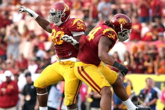 LOS ANGELES, CA - OCTOBER 26:  Defensive end Leonard Williams #94 and George Uko #90 of the USC Trojans celebrate a Williams' quarterback sack against the Utah Utes in the fourth quarter at Los Angeles Coliseum on October 26, 2013 in Los Angeles, Californ