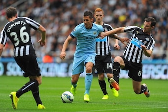 NEWCASTLE UPON TYNE, ENGLAND - AUGUST 17:  Newcastle player Mike Williamson (r) challenges Stevan Jovetic during the Barclays Premier League match between Newcastle United and Manchester City at St James' Park on August 17, 2014 in Newcastle upon Tyne, En