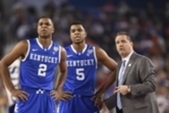 Apr 5, 2014; Arlington, TX, USA; Kentucky Wildcats head coach John Calipari talks to guard Andrew Harrison (5) and Aaron Harrison (2) on the sideline against the Wisconsin Badgers in the first half during the semifinals of the Final Four in the 2014 NCAA 