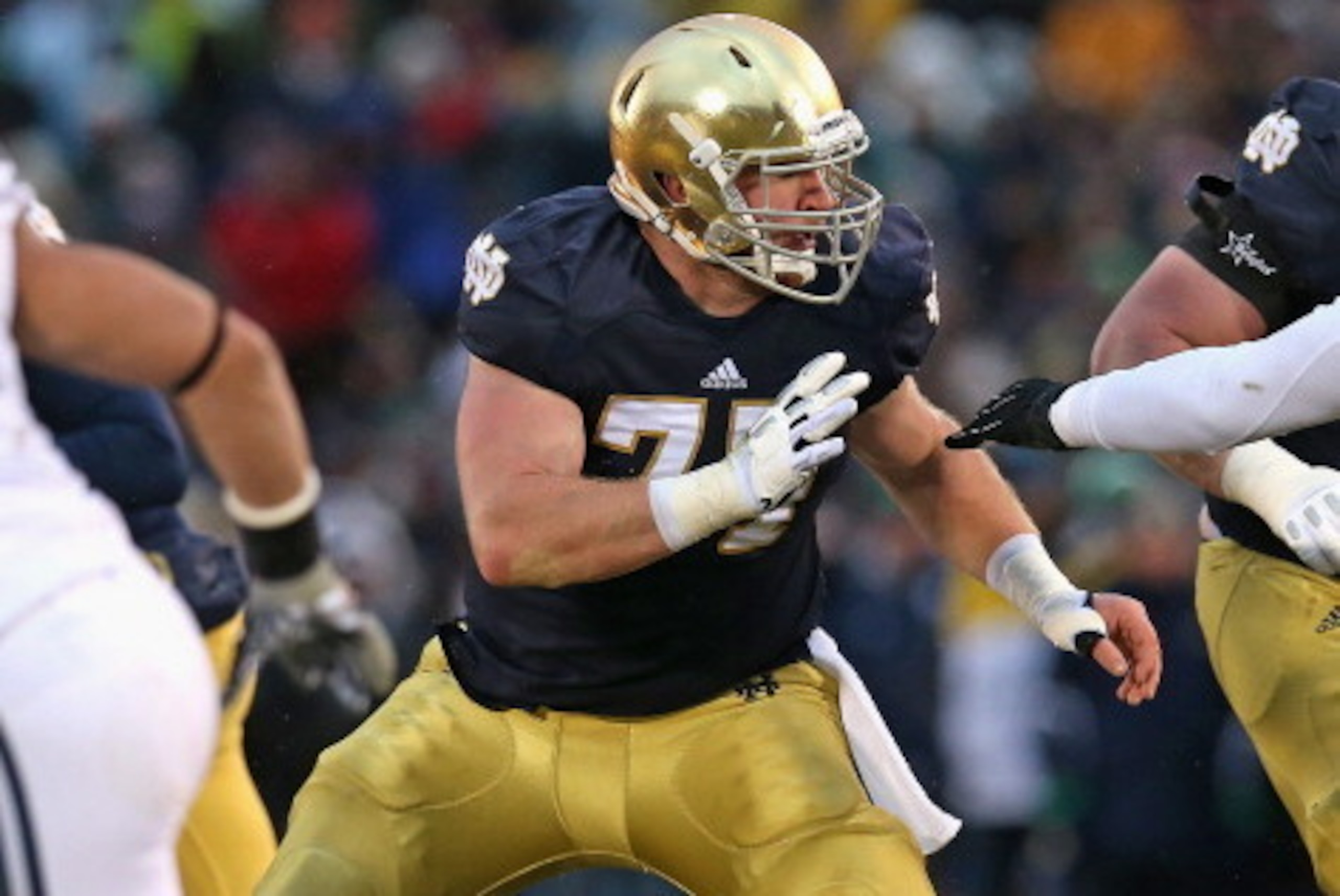 SOUTH BEND, IN - NOVEMBER 23: Matt Hegarty #77 of the Notre Dame Fighting Irish moves to block against the Brigham Young Cougars at Notre Dame Stadium on November 23, 2013 in South Bend, Indiana. Notre Dame defeated BYU 23-13. (Photo by Jonathan Daniel/Ge