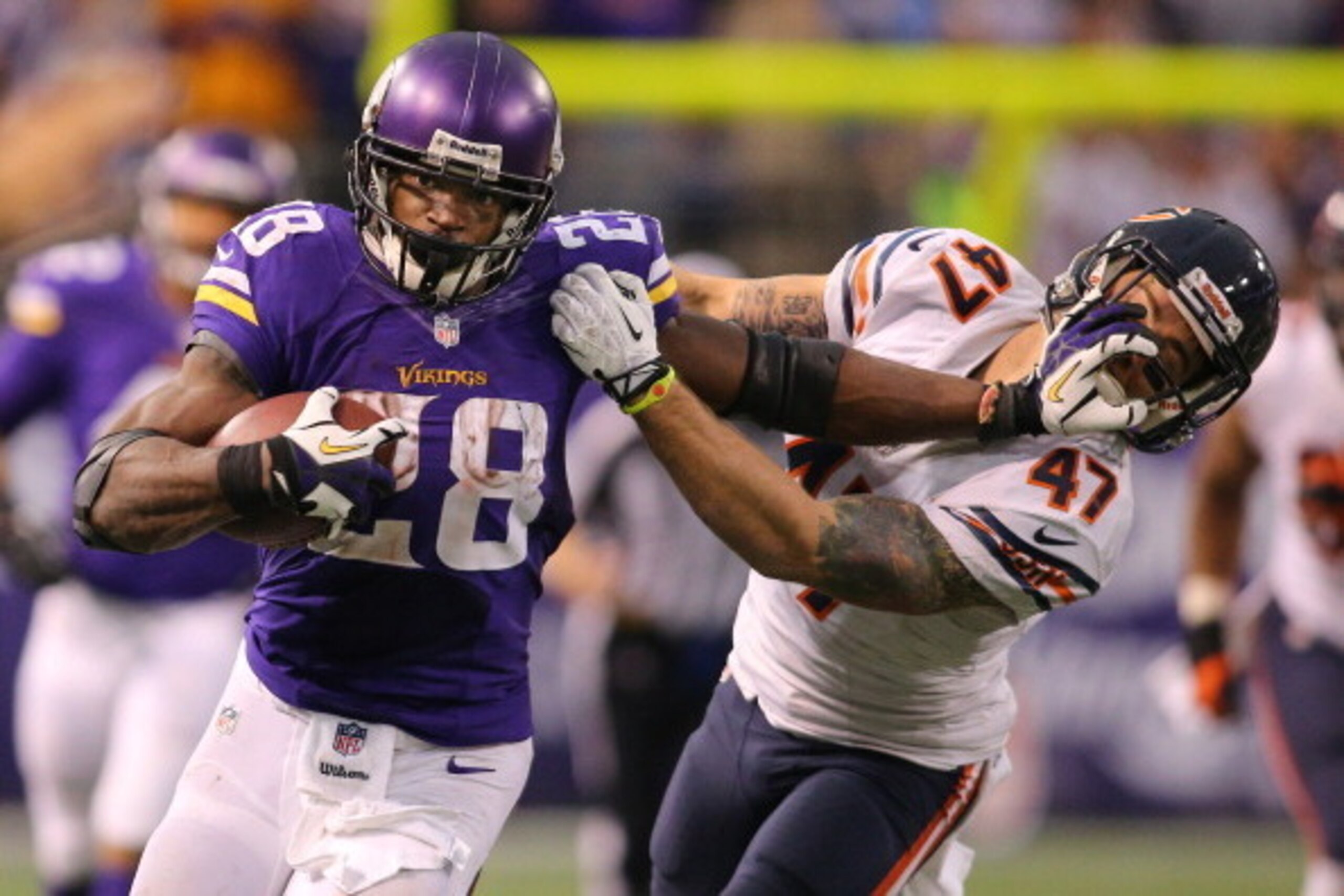 MINNEAPOLIS, MN - DECEMBER 1:  Adrian Peterson #28 of the Minnesota Vikings carries the ball for ten thousand career rushing yards against Chris Conte #47 of the Chicago Bears on December 1, 2013 at Mall of America Field at the Hubert Humphrey Metrodome i